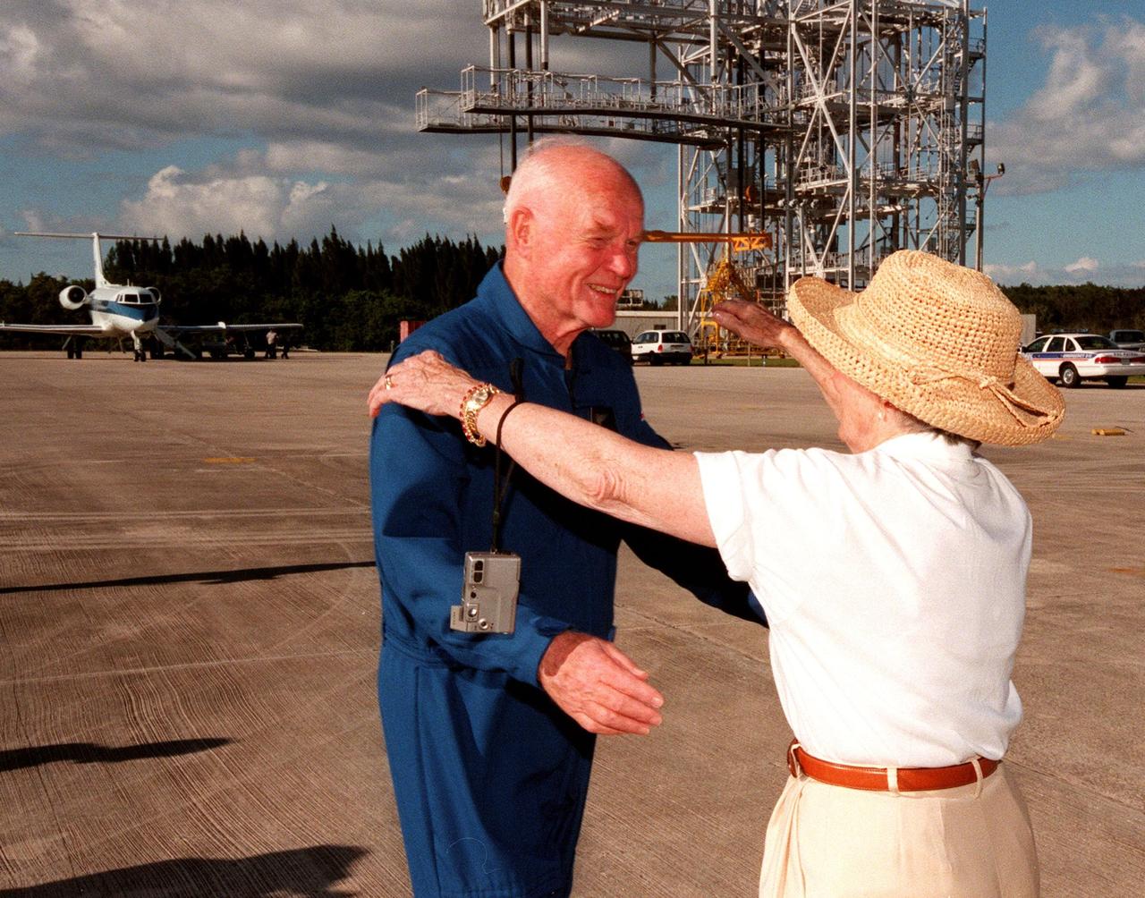STS-95 Payload Specialist John H. Glenn Jr., senator from Ohio, reaches to embrace his wife, Annie, after landing at Kennedy Space Center's Shuttle Landing Facility aboard a T-38 jet. Behind the couple is the mate/demate device used to raise and lower the orbiter from its shuttle carrier aircraft during ferry operations. Glenn and other crewmembers flew into KSC to make final preparations for launch. Targeted for liftoff at 2 p.m. on Oct. 29, the STS-95 mission includes research payloads such as the Spartan solar-observing deployable spacecraft, the Hubble Space Telescope Orbital Systems Test Platform, the International Extreme Ultraviolet Hitchhiker, as well as the SPACEHAB single module with experiments on space flight and the aging process. The mission is expected to last 8 days, 21 hours and 49 minutes, and return to KSC on Nov. 7. The other STS-95 crew members are Mission Commander Curtis L. Brown Jr., Pilot Steven W. Lindsey, Mission Specialist Scott E. Parazynski, Mission Specialist Stephen K. Robinson, Mission Specialist Pedro Duque, with the European Space Agency (ESA), and Payload Specialist Chiaki Mukai, with the National Space Development Agency of Japan (NASDA)
