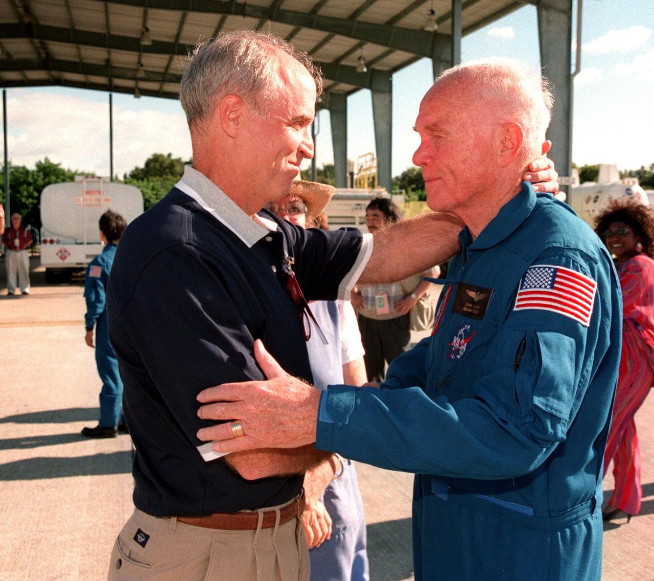 STS-95 Payload Specialist John H. Glenn Jr. (right), senator from Ohio, embraces his son, David, after landing at Kennedy Space Center's Shuttle Landing Facility aboard a T-38 jet. Barely visible behind them is Glenn's daughter, Lyn. Glenn and other crewmembers flew into KSC to make final preparations for launch. Targeted for liftoff at 2 p.m. on Oct. 29, the STS-95 mission includes research payloads such as the Spartan solar-observing deployable spacecraft, the Hubble Space Telescope Orbital Systems Test Platform, the International Extreme Ultraviolet Hitchhiker, as well as the SPACEHAB single module with experiments on space flight and the aging process. The mission is expected to last 8 days, 21 hours and 49 minutes, and return to KSC on Nov. 7. The other STS-95 crew members are Mission Commander Curtis L. Brown Jr., Pilot Steven W. Lindsey, Mission Specialist Scott E. Parazynski, Mission Specialist Stephen K. Robinson, Mission Specialist Pedro Duque, with the European Space Agency (ESA), and Payload Specialist Chiaki Mukai, with the National Space Development Agency of Japan (NASDA)