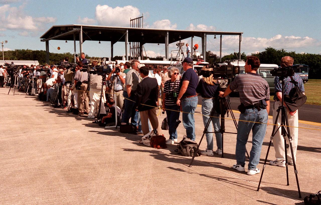 Waiting for the arrival of the STS-95 crewmembers at the Shuttle Landing Facility are 137 media representatives, a small sampling of more than 3,000 expected to attend the launch on Oct. 29. Flying into KSC to make final preparations for their launch were Mission Commander Curtis L. Brown Jr., Pilot Steven W. Lindsey, Mission Specialist Scott E. Parazynski, Mission Specialist Stephen K. Robinson, Mission Specialist Pedro Duque, with the European Space Agency (ESA), and Payload Specialist Chiaki Mukai, with the National Space Development Agency of Japan (NASDA). The STS-95 mission includes research payloads such as the Spartan solar-observing deployable spacecraft, the Hubble Space Telescope Orbital Systems Test Platform, the International Extreme Ultraviolet Hitchhiker, as well as the SPACEHAB single module with experiments on space flight and the aging process. The mission is expected to last 8 days, 21 hours and 49 minutes, and return to KSC on Nov. 7