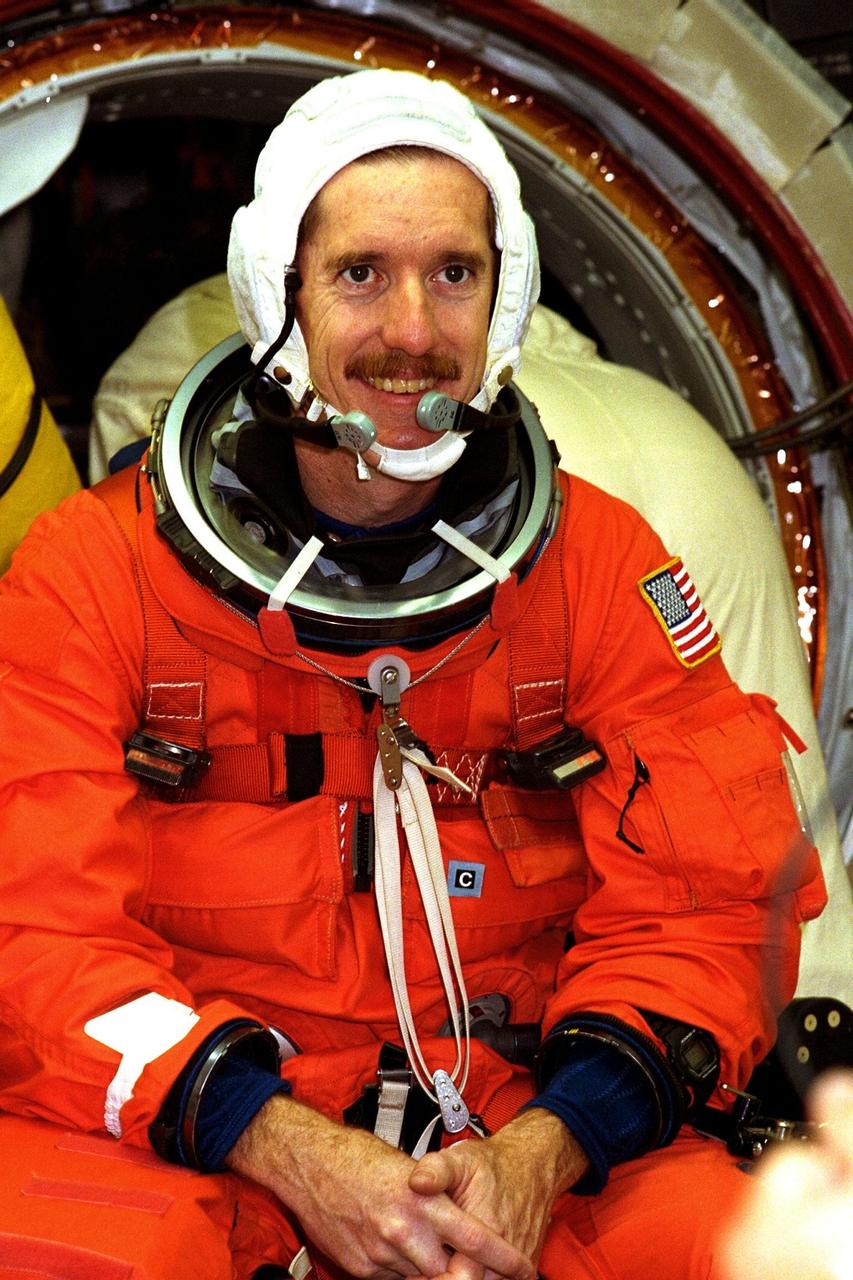 Smiling at the entrance to the orbiter is STS-89 Mission Specialist James Reilly, Ph.D., as he prepares to enter the Space Shuttle Endeavour at Launch Pad 39A with help from white room closeout crew members as part of Terminal Countdown Demonstration Test (TCDT) activities. The TCDT is held at KSC prior to each Space Shuttle flight to provide crews with an opportunity to participate in simulated countdown activities. The STS-89 mission will be the eighth docking of the Space Shuttle with the Russian Space Station Mir. After docking, Mission Specialist Andrew Thomas, Ph.D., will transfer to the space station, succeeding David Wolf, M.D., who will return to Earth aboard Endeavour. Dr. Thomas will live and work on Mir until June. STS-89 is scheduled for a Jan. 22 liftoff at 9:48 p.m