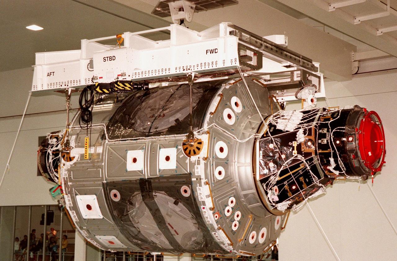 In the Space Station Processing Facility, a closeup view shows the overhead crane holding the Unity connecting module as it moves it to the payload canister for transfer to the launch pad. Part of the International Space Station (ISS), Unity is scheduled for launch aboard Space Shuttle Endeavour on Mission STS-88 in December. The Unity is a connecting passageway to the living and working areas of ISS. While on orbit, the flight crew will deploy Unity from the payload bay and attach Unity to the Russian-built Zarya control module which will be in orbit at that time
