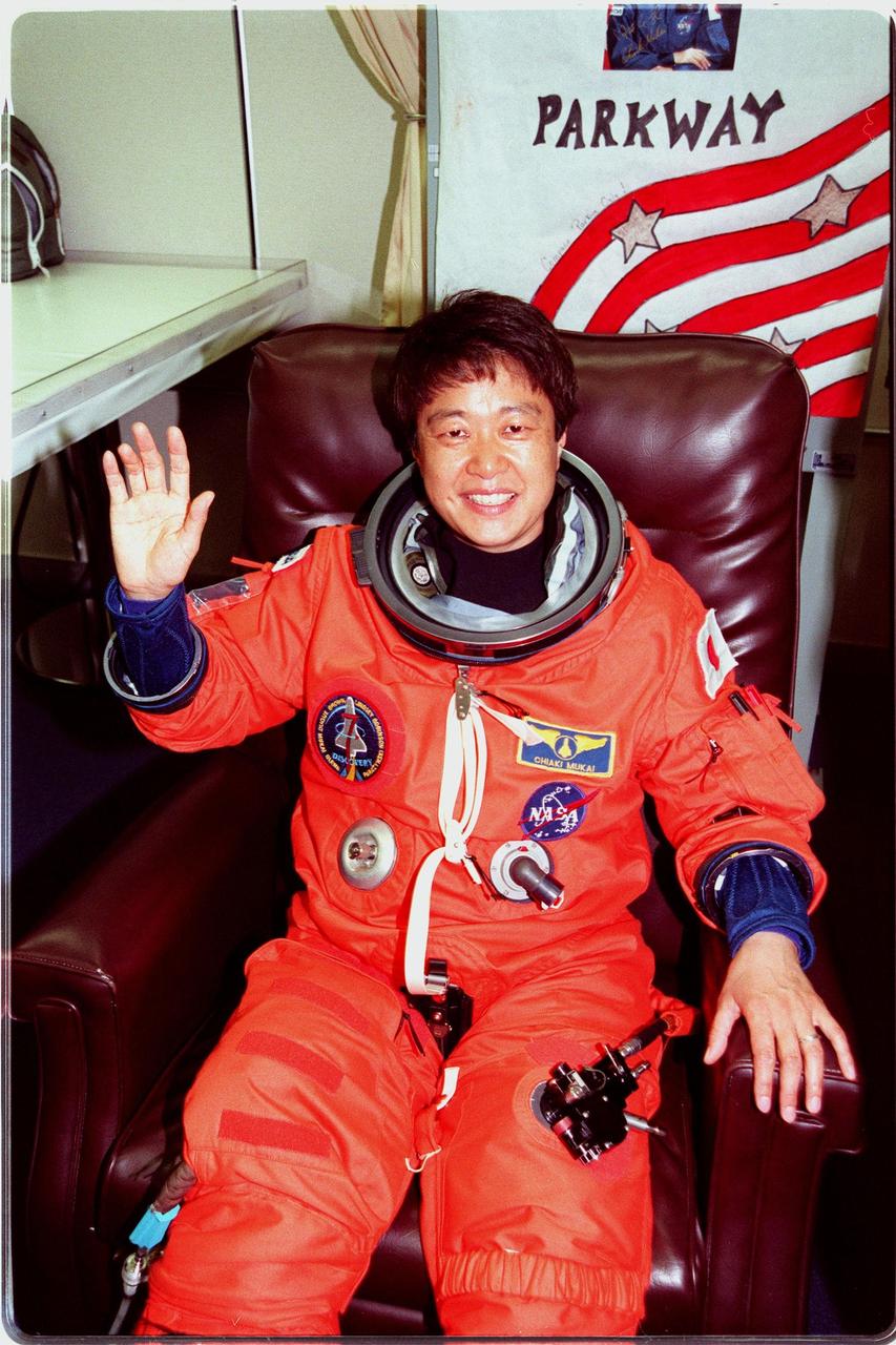 STS-95 Payload Specialist Chiaki Mukai, (M.D., Ph.D.), with the National Space Development Agency of Japan (NASDA), smiles as she dons her flight suit in the Operations and Checkout Building. The final fitting takes place prior to the crew walkout and transport to Launch Pad 39B. Targeted for launch at 2 p.m. EST on Oct. 29, the mission is expected to last 8 days, 21 hours and 49 minutes, and return to KSC at 11:49 a.m. EST on Nov. 7. The STS-95 mission includes research payloads such as the Spartan solar-observing deployable spacecraft, the Hubble Space Telescope Orbital Systems Test Platform, the International Extreme Ultraviolet Hitchhiker, as well as the SPACEHAB single module with experiments on space flight and the aging process