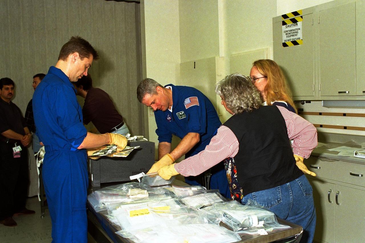STS-90 Payload Specialists James Pawelczyk, Ph.D. (at left), and Jay Buckey Jr., M.D., examine items to be used during the Crew Equipment Interface Test (CEIT) in Kennedy Space Center's (KSC's) Operations and Checkout Building, where the Neurolab payload is undergoing processing. The CEIT gives astronauts an opportunity to get a hands-on look at the payloads with which they will be working on-orbit. STS-90 is scheduled to launch aboard the Shuttle Columbia from KSC on April 2. Investigations during the Neurolab mission will focus on the effects of microgravity on the nervous system. Specifically, experiments will study the adaptation of the vestibular system, the central nervous system, and the pathways that control the ability to sense location in the absence of gravity, as well as the effect of microgravity on a developing nervous system