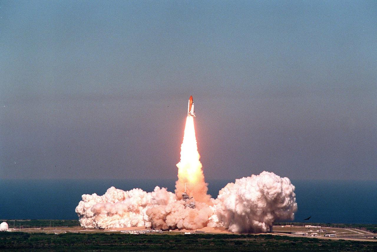 As if sprung from the rolling exhaust clouds below, Space Shuttle Discovery shoots into the heavens over the blue Atlantic Ocean from Launch Pad 39B on mission STS-95. Lifting off at 2:19 p.m. EST, Discovery carries a crew of six, including Payload Specialist John H. Glenn Jr., senator from Ohio, who is making his second voyage into space after 36 years. Other crew members are Mission Commander Curtis L. Brown Jr., Pilot Steven W. Lindsey, Payload Specialist Chiaki Mukai, (M.D., Ph.D.), with the National Space Development Agency of Japan (NASDA), Mission Specialist Stephen K. Robinson, Mission Specialist Pedro Duque of Spain, representing the European Space Agency (ESA), and Mission Specialist Scott E. Parazynski. The STS-95 mission includes research payloads such as the Spartan solar-observing deployable spacecraft, the Hubble Space Telescope Orbital Systems Test Platform, the International Extreme Ultraviolet Hitchhiker, as well as the SPACEHAB single module with experiments on space flight and the aging process. Discovery is expected to return to KSC at 11:49 a.m. EST on Nov. 7