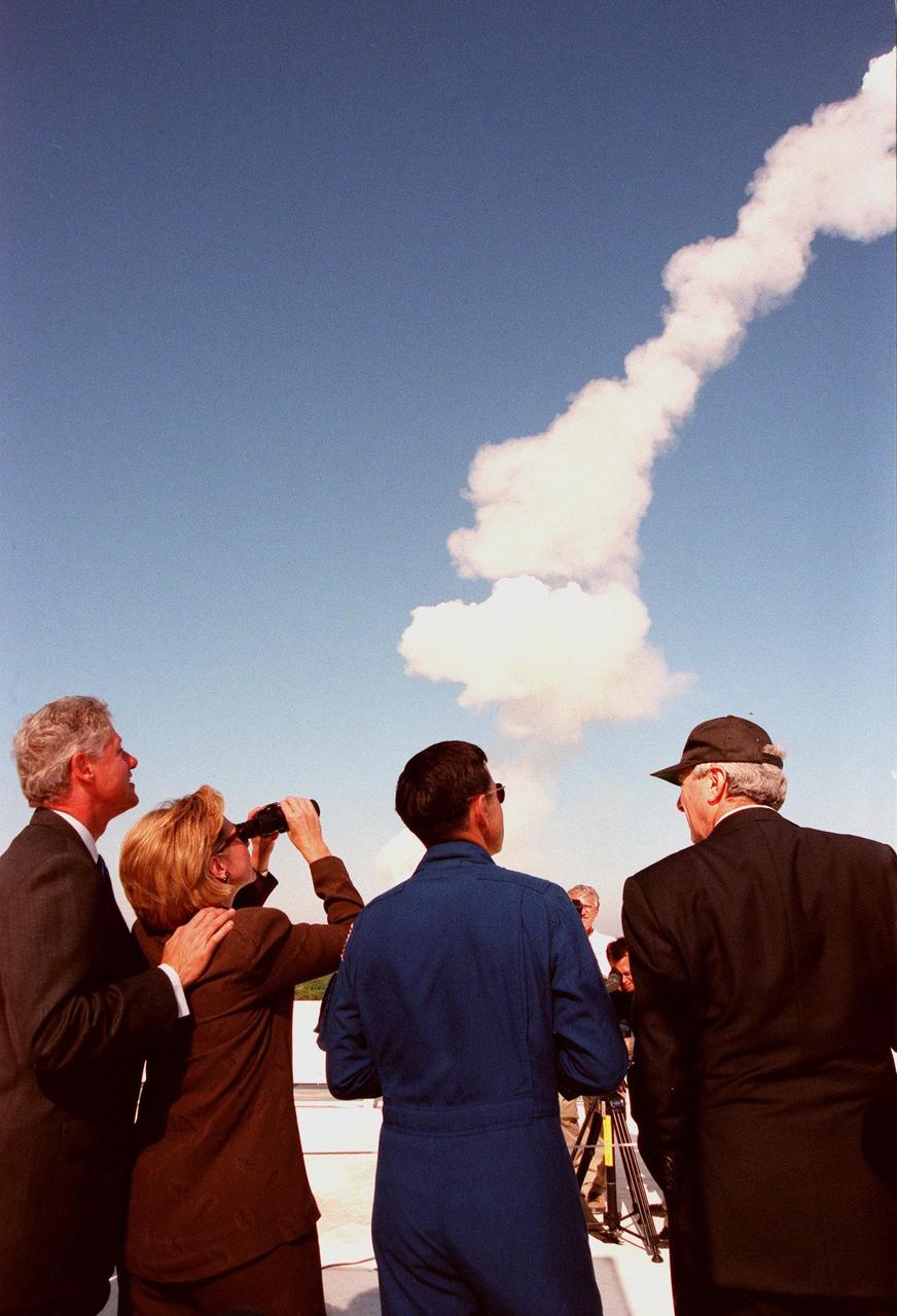 Watching a successful launch of Space Shuttle Discovery from the roof of the Launch Control Center are (left to right) U.S. President Bill Clinton, First Lady Hillary Rodham Clinton, Astronaut Robert Cabana and NASA Administrator Daniel Goldin. This was the first launch of a Space Shuttle to be viewed by President Clinton, or any President to date. They attended the launch to witness the return to space of American legend John H. Glenn Jr., payload specialist on mission STS-95. Cabana will command the crew of STS-88, the first Space Shuttle mission to carry hardware to space for the assembly of the International Space Station, targeted for liftoff on Dec. 3