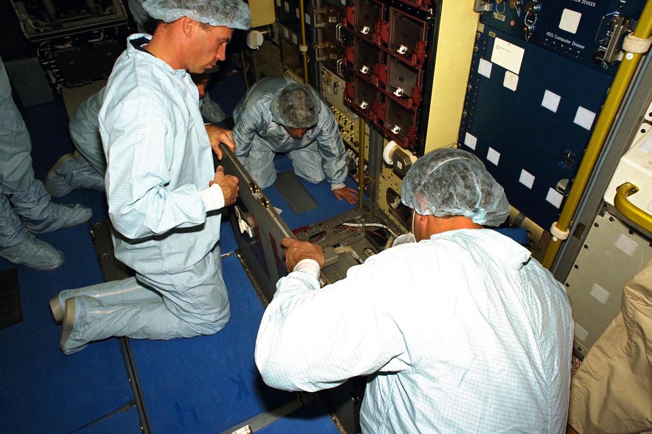 STS-90 Payload Specialist James Pawelczyk, Ph.D., holds up a panel as one of the items used during the Crew Equipment Interface Test (CEIT) in Kennedy Space Center's (KSC's) Operations and Checkout Building, where the Neurolab payload is undergoing processing. The CEIT gives astronauts an opportunity to get a hands-on look at the payloads with which they will be working on-orbit. STS-90 is scheduled to launch aboard the Shuttle Columbia from KSC on April 2. Investigations during the Neurolab mission will focus on the effects of microgravity on the nervous system. Specifically, experiments will study the adaptation of the vestibular system, the central nervous system, and the pathways that control the ability to sense location in the absence of gravity, as well as the effect of microgravity on a developing nervous system