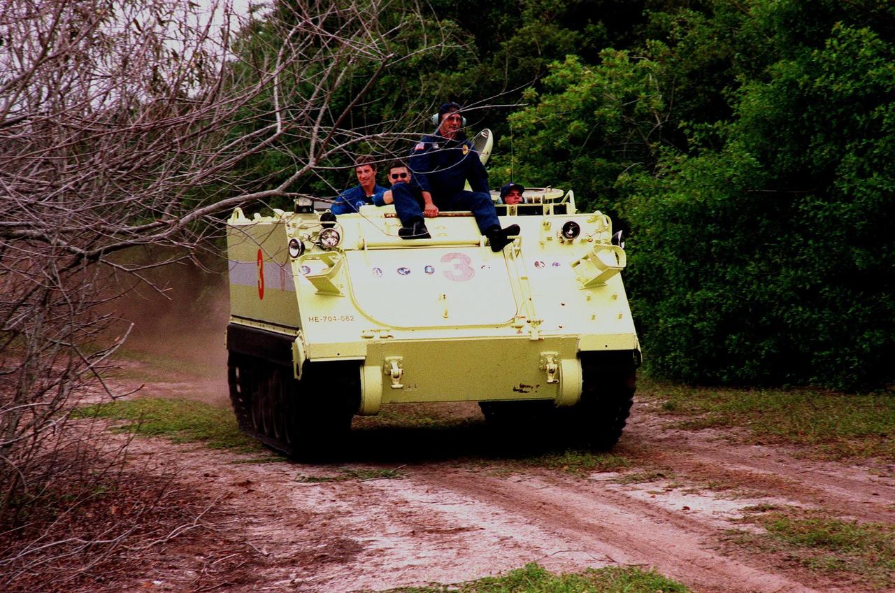 STS-88 Pilot Frederick W. "Rick" Sturckow (right) operates an M-113, an armored personnel carrier, as part of emergency egress training under the watchful eye of instructor George Hoggard during Terminal Countdown Demonstration Test (TCDT) activities. The TCDT also provides the crew with simulated countdown exercises and opportunities to inspect their mission payloads in the orbiter's payload bay. Mission STS-88 is targeted for launch on Dec. 3, 1998. It is the first U.S. flight for the assembly of the International Space Station and will carry the Unity connecting module. Others in the STS-88 crew are Mission Commander Robert D. Cabana and Mission Specialists Nancy J. Currie, Jerry L. Ross, James H. Newman, and Sergei Konstantinovich Krikalev, a Russian cosmonaut