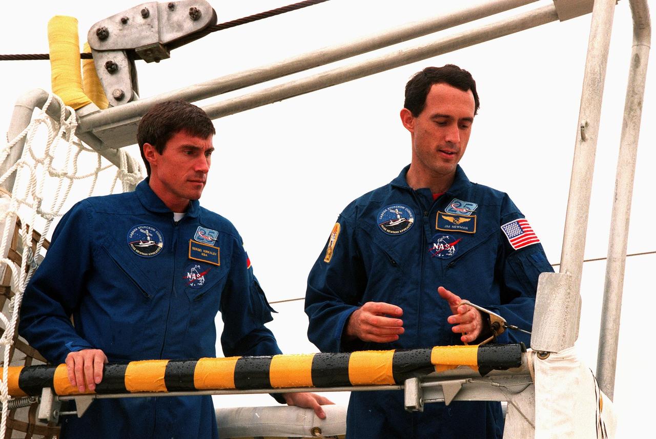 KENNEDY SPACE CENTER,  Fla. -- STS-88 Mission Specialists Sergei Krikalev and James H. Newman practice emergency egress procedures in a slidewire basket at Launch Pad 39A as part of Terminal Countdown Demonstration Test (TCDT) activities, a dress rehearsal for launch. Mission STS-88 is targeted for launch on Dec. 3, 1998. It is the first U.S. flight for the assembly of the International Space Station and will carry the Unity connecting module