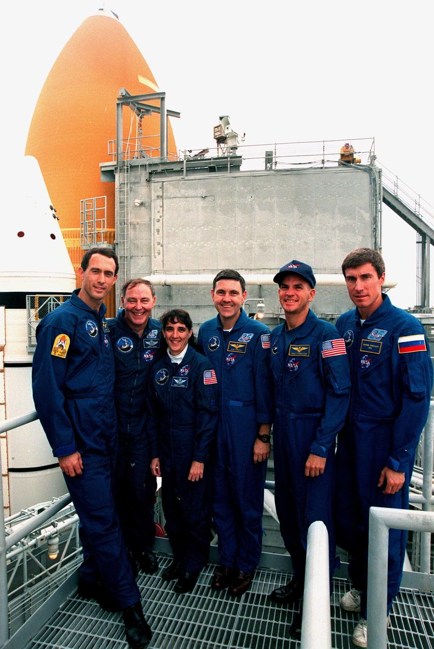 KENNEDY SPACE CENTER,  Fla. -- STS-88 crew members pose for a photograph during a break in emergency egress training on launch pad 39A. They are (left to right) Mission Specialists James H. Newman , Jerry L. Ross and Nancy J. Currie, Mission Commander Robert D. Cabana, Pilot Frederick W. "Rick" Sturckow and Mission Specialist Sergei Krikalev, a Russian cosmonaut. The crew are at KSC to participate in the Terminal Countdown Demonstration Test (TCDT), a dress rehearsal for launch. Mission STS-88 is targeted for launch on Dec. 3, 1998. It is the first U.S. flight for the assembly of the International Space Station and will carry the Unity connecting module