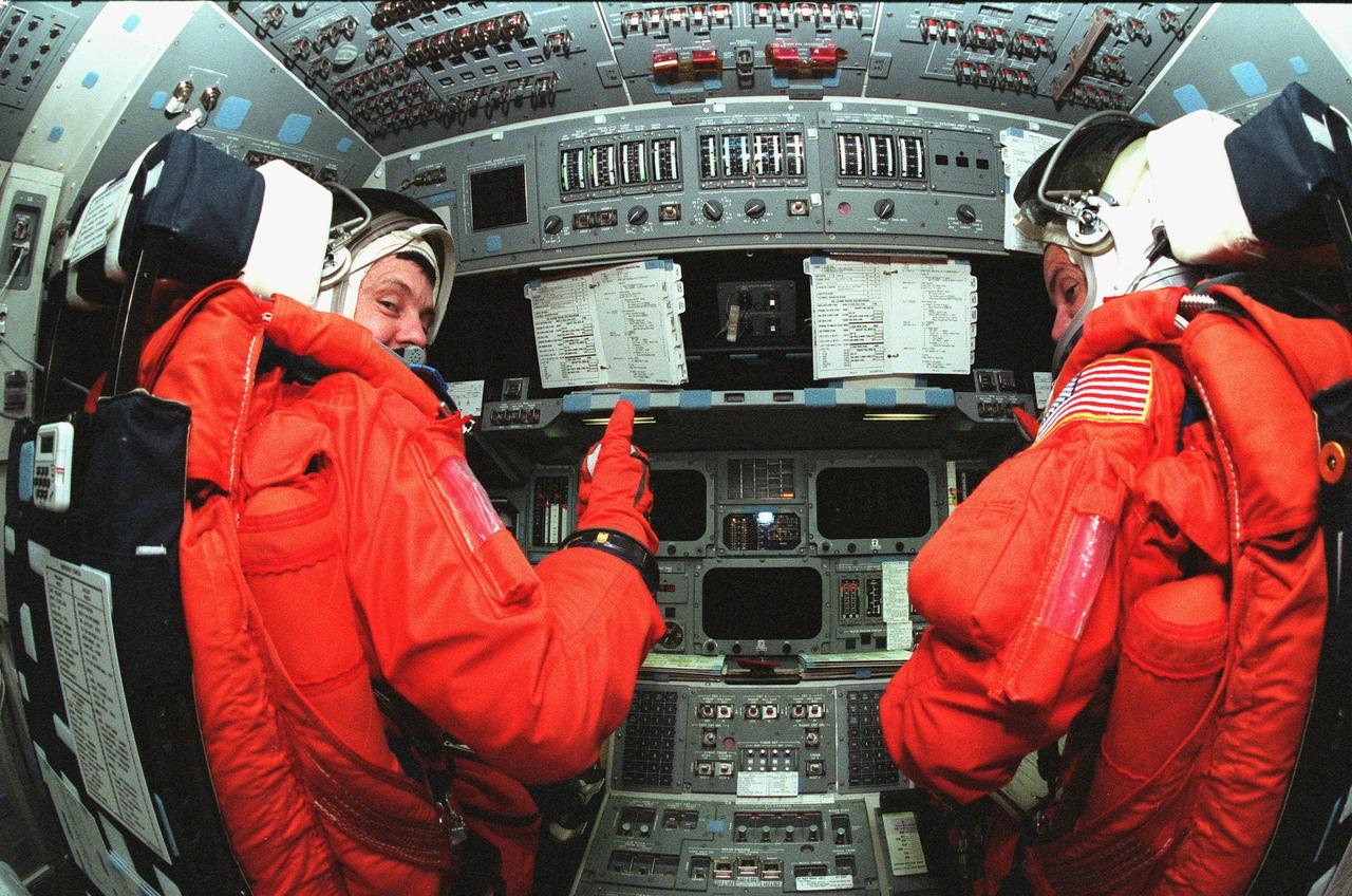STS-88 Mission Commander Robert D. Cabana (left) and Pilot Frederick W. "Rick" Sturckow (right) take their seats in the flight deck inside orbiter Endeavour during Terminal Countdown Demonstration Activities (TCDT). The TCDT includes mission familiarization activities, emergency egress training, and the simulated main engine cut-off exercise. Mission STS-88 is targeted for launch on Dec. 3, 1998. It is the first U.S. flight for the assembly of the International Space Station and will carry the Unity connecting module. Unity will be mated with the already orbiting Russian-built Zarya control module. The 12-day mission includes three planned spacewalks to connect power, data and utility lines and install exterior equipment