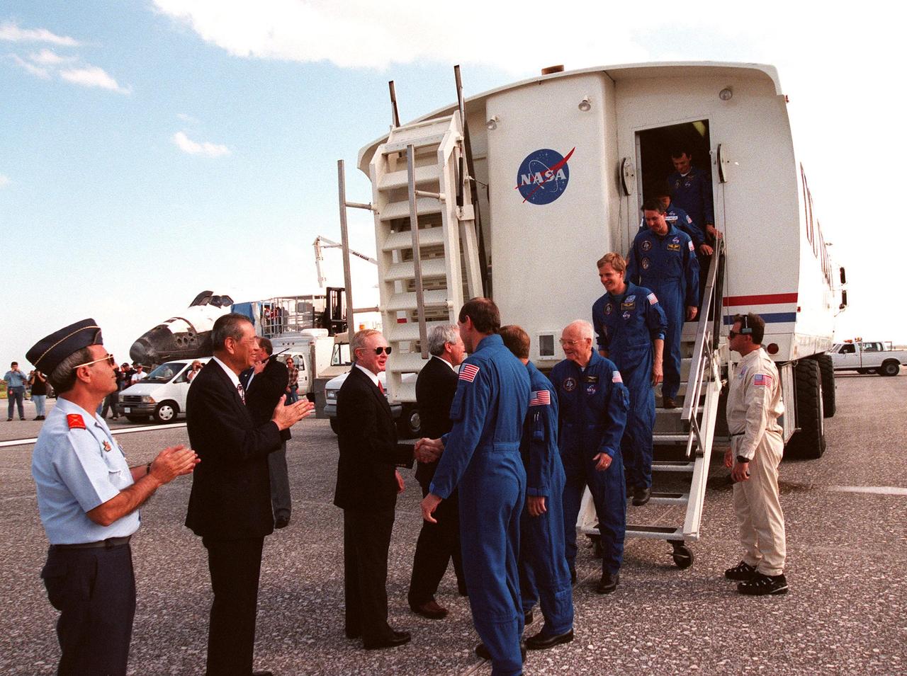 Following touchdown at 12:04 p.m. EST at the Shuttle Landing Facility, the STS-95 crew leave the Crew Transport Vehicle where they are met by (left to right) a Spanish dignitary; Isao Uchida, president of the National Space Development Agency of Japan (NASDA); Center Director Roy Bridges; and NASA Administrator Daniel Goldin. The crew, from left to right, are Mission Commander Curtis L. Brown Jr. (shaking hands with Bridges); Pilot Steven W. Lindsey; Payload Specialist John H. Glenn Jr., a senator from Ohio and one of the original Mercury 7 astronauts; Mission Specialist Scott E. Parazynski; Mission Specialist Stephen K. Robinson; Payload Specialist Chiaki Mukai, with the National Space Development Agency of Japan (NASDA); and Mission Specialist Pedro Duque of Spain, with the European Space Agency (ESA). The successful mission lasted nine days and included research payloads such as the Spartan solar-observing deployable spacecraft, the Hubble Space Telescope Orbital Systems Test Platform, the International Extreme Ultraviolet Hitchhiker, as well as the SPACEHAB single module with experiments on space flight and the aging process