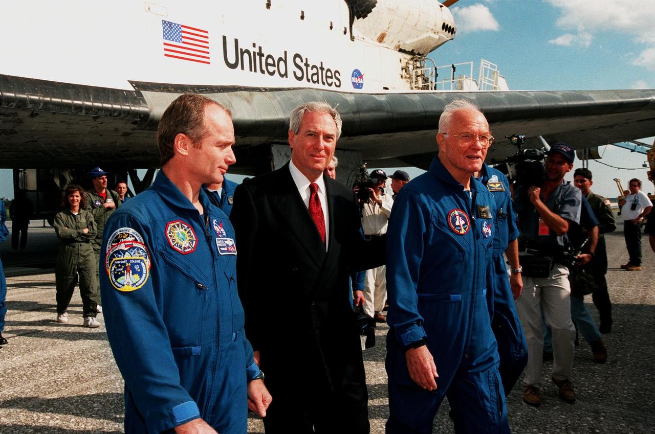 Charles Precourt, chief of the Astronaut office in Houston, and Daniel Goldin, NASA administrator, welcome back to Earth Senator John H. Glenn Jr., from a successful mission STS-95 aboard orbiter Discovery. Glenn served as payload specialist, one of a crew of seven that included Mission Commander Curtis L. Brown Jr.; Pilot Steven W. Lindsey; Mission Specialists Stephen K. Robinson, Scott E. Parazynski and Pedro Duque of Spain, with the European Space Agency; and Payload Specialist Chiaki Mukai, M.D., with the National Space Development Agency of Japan (NASDA). They landed at the Shuttle Landing Facility at 12:04 p.m. EST, after 9 days in space, traveling 3.6 million miles. The mission included research payloads such as the Spartan solar-observing deployable spacecraft, the Hubble Space Telescope Orbital Systems Test Platform, the International Extreme Ultraviolet Hitchhiker, as well as the SPACEHAB single module with experiments on space flight and the aging process