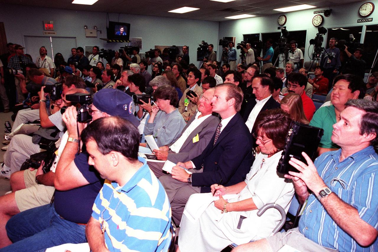 Media representatives from all over the world fill the Kennedy Space Center Press Site Auditorium for a press conference held by the STS-95 crew before their return to the Johnson Space Center in Houston, Texas. The STS-95 crew members are Mission Commander Curtis L. Brown Jr.; Pilot Steven W. Lindsey; Mission Specialist and Payload Commander Stephen K. Robinson; Mission Specialist Scott E. Parazynski; Mission Specialist Pedro Duque, with the European Space Agency (ESA); Payload Specialist Chiaki Mukai, with the National Space Development Agency of Japan (NASDA); and Payload Specialist John H. Glenn Jr., a senator from Ohio and one of the original seven Project Mercury astronauts. The STS-95 mission ended with landing at Kennedy Space Center's Shuttle Landing Facility at 12:04 p.m. EST on Nov. 7. The mission included research payloads such as the Spartan-201 solar-observing deployable spacecraft, the Hubble Space Telescope Orbital Systems Test Platform, the International Extreme Ultraviolet Hitchhiker, as well as a SPACEHAB single module with experiments on space flight and the aging process