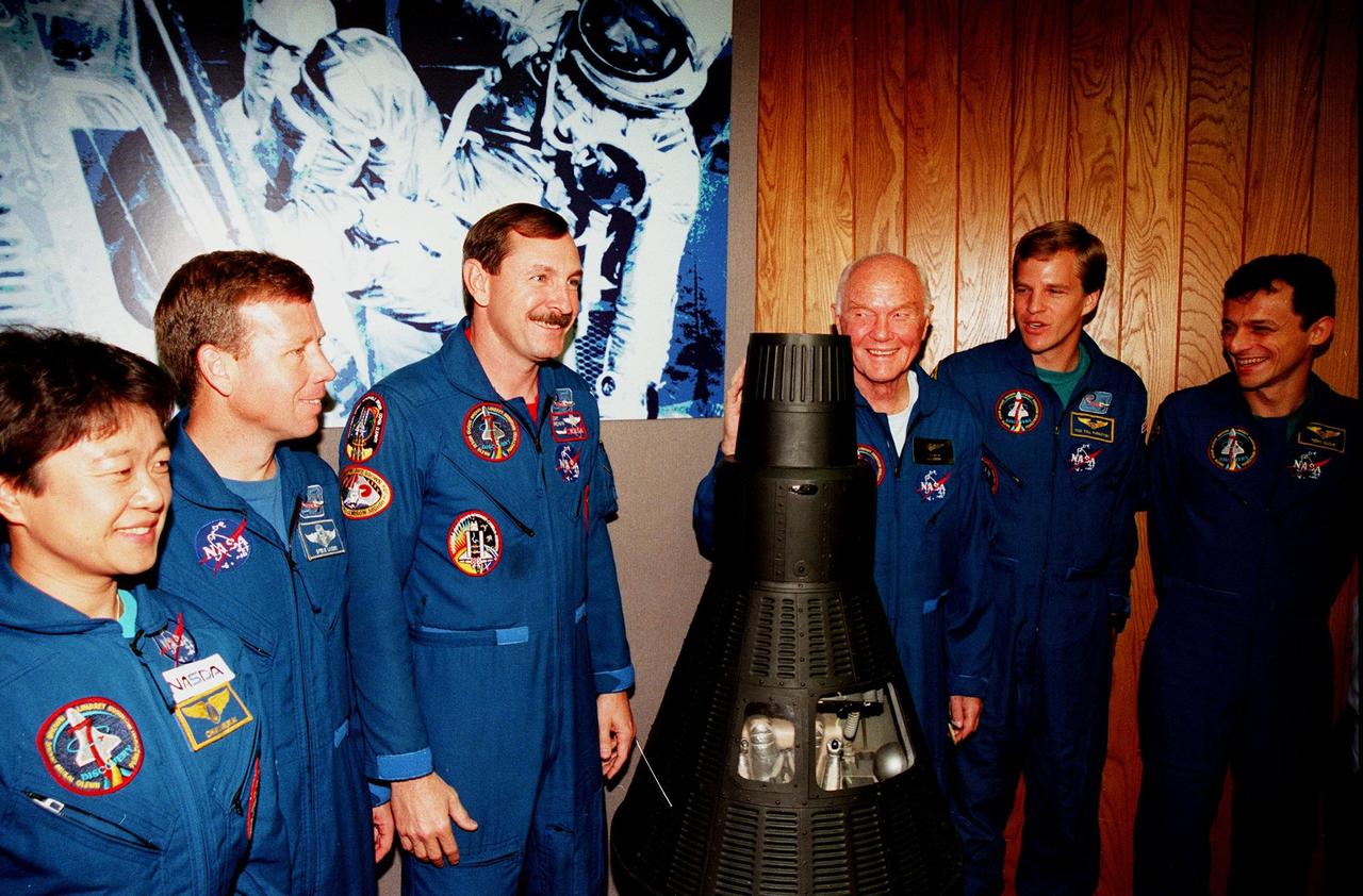 Before returning to the Johnson Space Center in Houston, Texas, members of the STS-95 crew pose with a model of a Mercury capsule following a media briefing at the Kennedy Space Center Press Site Auditorium . From left to right are Payload Specialist Chiaki Mukai, with the National Space Development Agency of Japan (NASDA); Pilot Steven W. Lindsey; Mission Commander Curtis L. Brown Jr.; Friendship 7; Payload Specialist John H. Glenn Jr., a senator from Ohio and one of the original seven Project Mercury astronauts; Mission Specialist Scott E. Parazynski; and Mission Specialist Pedro Duque, with the European Space Agency (ESA). Also on the crew is Mission Specialist and Payload Commander Stephen K. Robinson (not shown). The STS-95 mission ended with landing at Kennedy Space Center's Shuttle Landing Facility at 12:04 p.m. EST on Nov. 7. The mission included research payloads such as the Spartan-201 solar-observing deployable spacecraft, the Hubble Space Telescope Orbital Systems Test Platform, the International Extreme Ultraviolet Hitchhiker, as well as a SPACEHAB single module with experiments on space flight and the aging process