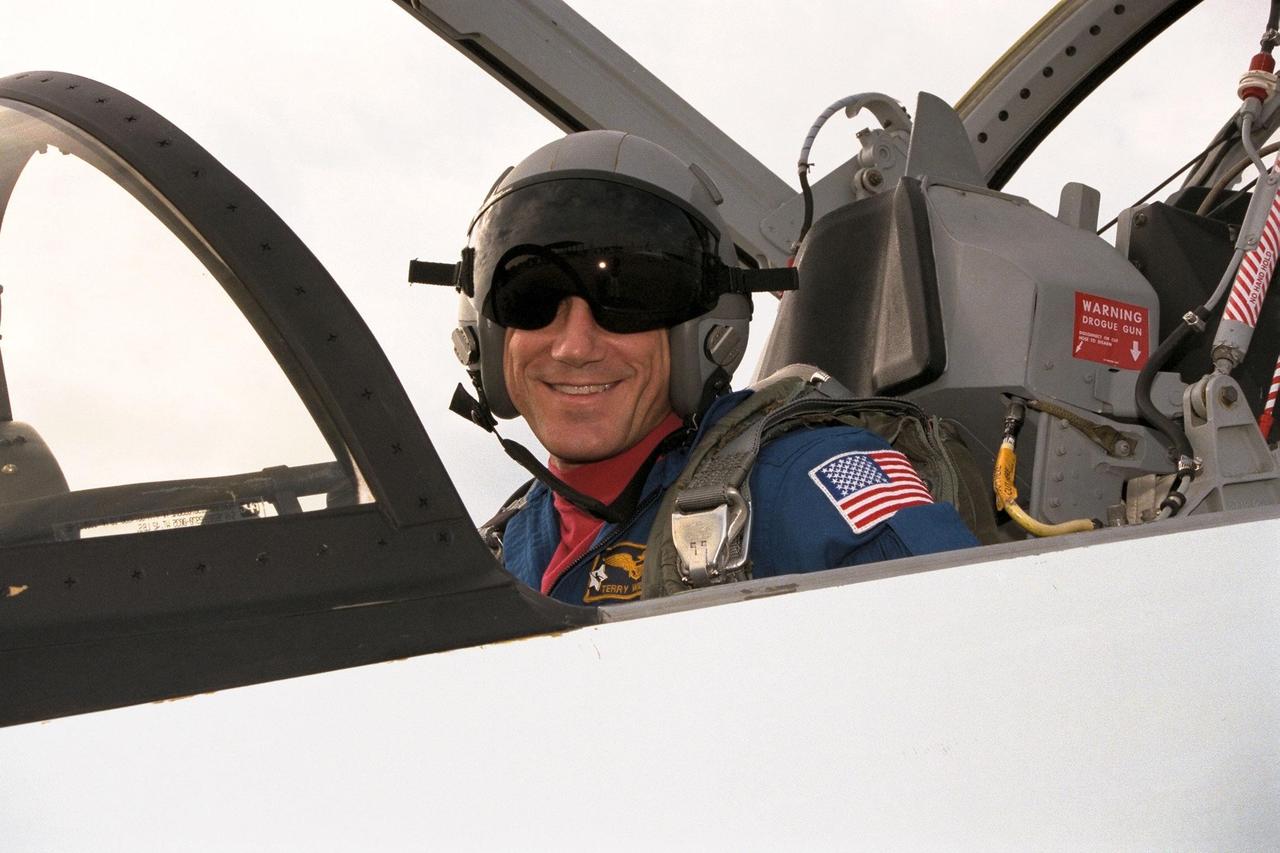 STS-89 Commander Terrence Wilcutt arrives at the KSC Shuttle Landing Facility in one of the T-38 aircraft traditionally flown by the astronaut corps. The eight STS-89 crew members flew into KSC from Johnson Space Center as final preparations are under way toward the scheduled liftoff on Jan. 22 of the Space Shuttle Endeavour on the eighth mission to dock with the Russian Space Station Mir. After docking, STS-89 Mission Specialist Andrew Thomas, Ph.D., will transfer to the space station, succeeding David Wolf, M.D., who will return to Earth aboard Endeavour. Dr. Thomas will live and work on Mir until June. STS-89 is scheduled for a Jan. 22 liftoff at 9:48 p.m. EST