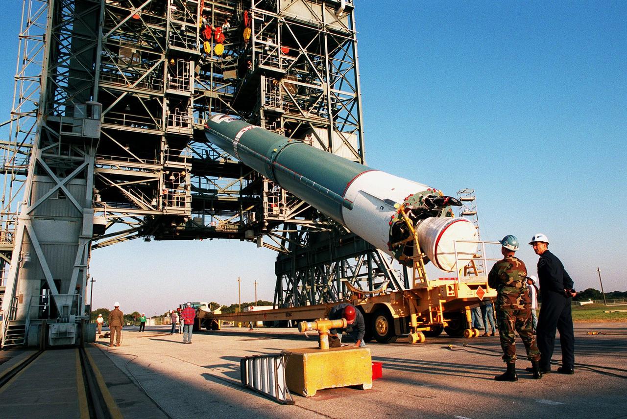 KENNEDY SPACE CENTER, FLA. -- On Pad 17A at Cape Canaveral Air Station, cables lift the Delta II rocket into position for launch. Scheduled for launch on Dec. 10, 1998, the rocket is carrying the Mars Climate Orbiter. The orbiter is heading for Mars where it will primarily support its companion Mars Polar Lander spacecraft, which is planned for launch on Jan. 3, 1999. The orbiter's instruments will monitor the Martian atmosphere and image the planet's surface on a daily basis for one Martian year (1.8 Earth years). It will observe the appearance and movement of atmospheric dust and water vapor, as well as characterize seasonal changes on the surface. The detailed images of the surface features will provide important clues to the planet's early climate history and give scientists more information about possible liquid water reserves beneath the surface
