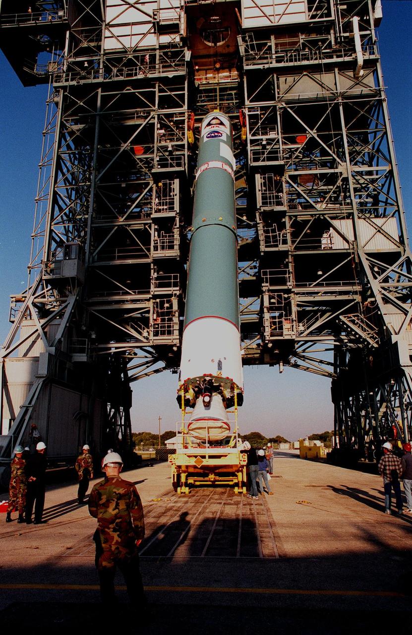 KENNEDY SPACE CENTER, FLA. -- On Pad 17A at Cape Canaveral Air Station, workers on the ground watch as cables lift a Delta II rocket into vertical position. Scheduled for launch on Dec. 10, 1998, the rocket is carrying the Mars Climate Orbiter. The orbiter is heading for Mars where it will primarily support its companion Mars Polar Lander spacecraft, which is planned for launch on Jan. 3, 1999. The orbiter's instruments will monitor the Martian atmosphere and image the planet's surface on a daily basis for one Martian year (1.8 Earth years). It will observe the appearance and movement of atmospheric dust and water vapor, as well as characterize seasonal changes on the surface. The detailed images of the surface features will provide important clues to the planet's early climate history and give scientists more information about possible liquid water reserves beneath the surface