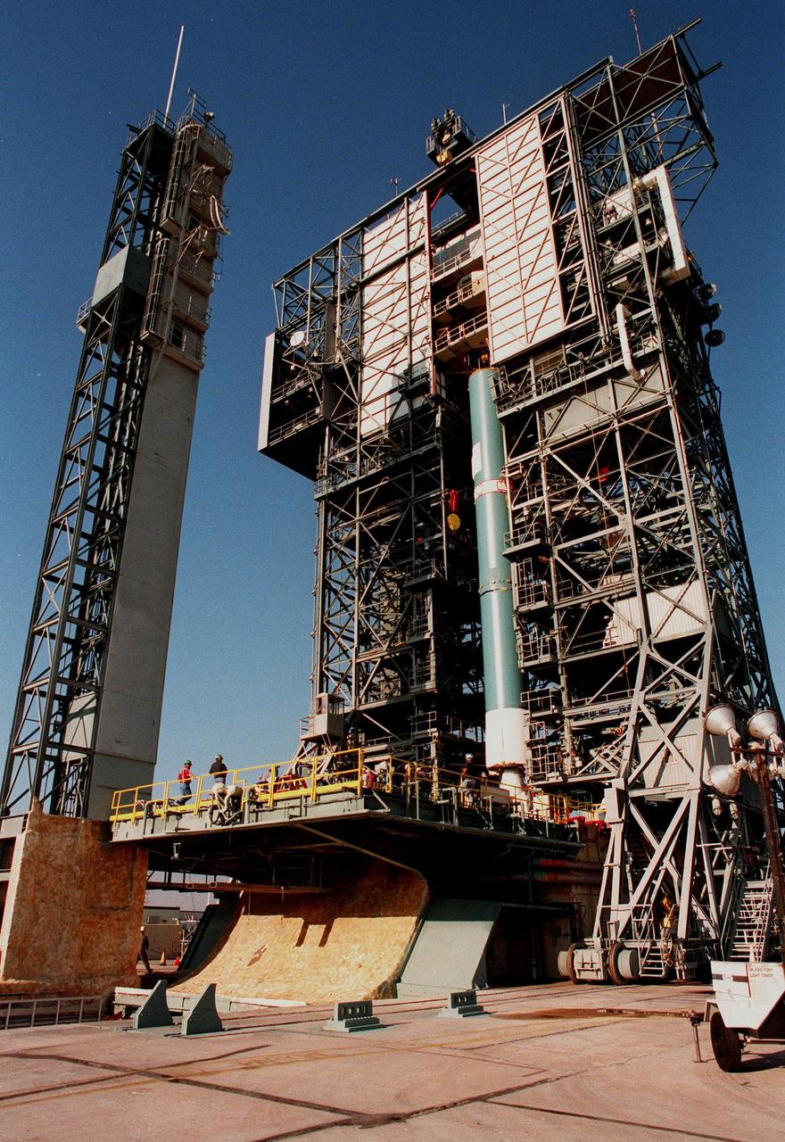 KENNEDY SPACE CENTER, FLA. -- On Pad 17A at Cape Canaveral Air Station, a Delta II rocket is maneuvered into position for launch on Dec. 10, 1998. The rocket is carrying the Mars Climate Orbiter which will head for Mars primarily to support its companion Mars Polar Lander spacecraft, which is planned for launch on Jan. 3, 1999. The orbiter's instruments will monitor the Martian atmosphere and image the planet's surface on a daily basis for one Martian year (1.8 Earth years). It will observe the appearance and movement of atmospheric dust and water vapor, as well as characterize seasonal changes on the surface. The detailed images of the surface features will provide important clues to the planet's early climate history and give scientists more information about possible liquid water reserves beneath the surface