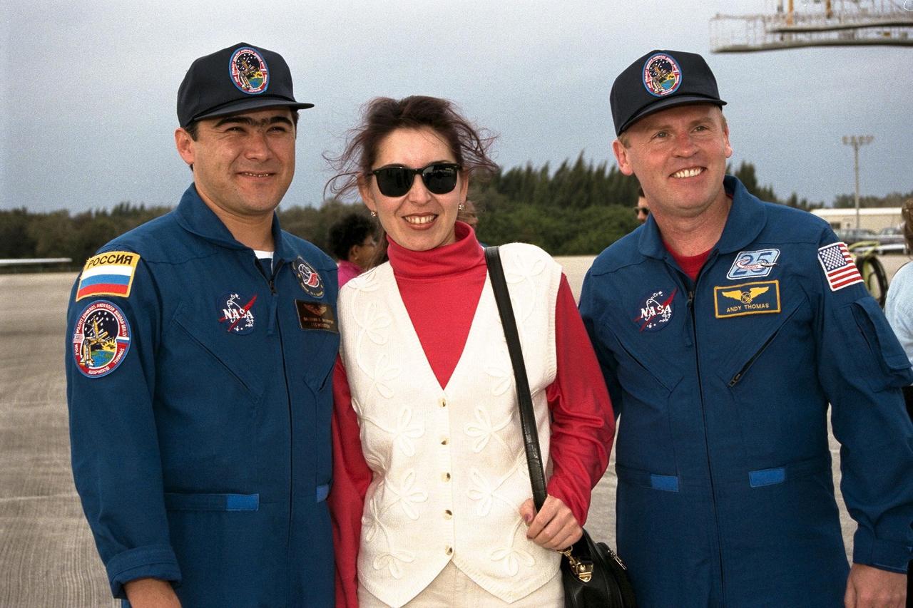 STS-89 Mission Specialist Salizhan Sharipov of the Russian Space Agency, at left, poses with his wife, Nadezhda Sharipova, and Mission Specialist Andrew Thomas, Ph.D., at right, shortly after arrival at the KSC Shuttle Landing Facility. The eight STS-89 crew members flew into KSC from Johnson Space Center as final preparations are under way toward the scheduled liftoff on Jan. 22 of the Space Shuttle Endeavour on the eighth mission to dock with the Russian Space Station Mir. After docking, Dr. Thomas will transfer to the space station, succeeding David Wolf, M.D., who will return to Earth aboard Endeavour. Dr. Thomas will live and work on Mir until June. STS-89 is scheduled for a Jan. 22 liftoff at 9:48 p.m. EST
