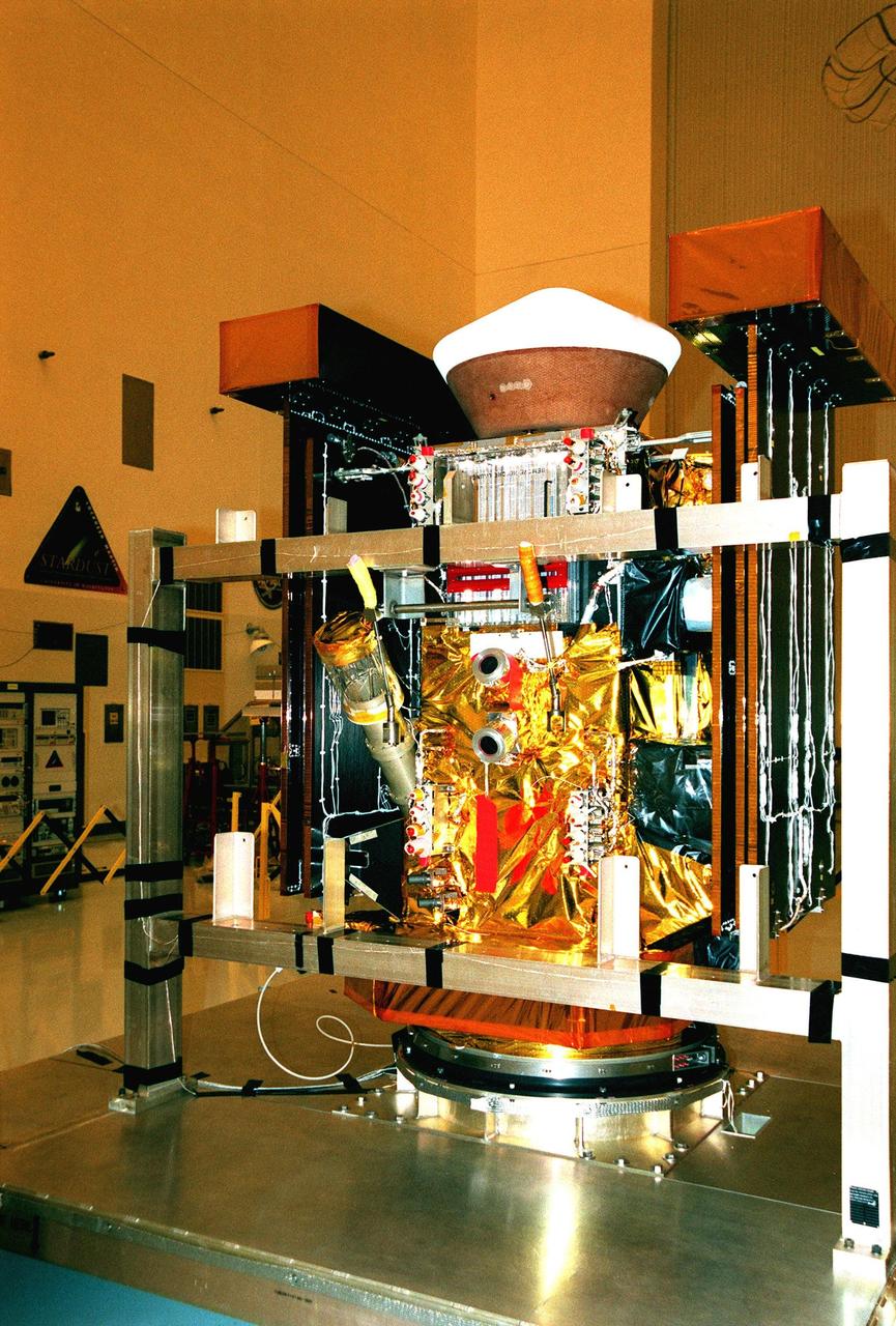 The Stardust spacecraft sits in the Payload Hazardous Service Facility waiting to undergo installation and testing of the solar arrays, plus final installation and testing of spacecraft instruments followed by an overall spacecraft functional test. At the top is the re-entry capsule. Built by Lockheed Martin Astronautics near Denver, Colo., for the Jet Propulsion Laboratory (JPL) and NASA, the spacecraft Stardust will use a unique medium called aerogel to capture comet particles flying off the nucleus of comet Wild 2 in January 2004, plus collect interstellar dust for later analysis. Stardust will be launched aboard a Boeing Delta 7426 rocket from Complex 17, Cape Canaveral Air Station, targeted for Feb. 6, 1999. The collected samples will return to Earth in the re-entry capsule to be jettisoned from Stardust as it swings by Earth in January 2006
