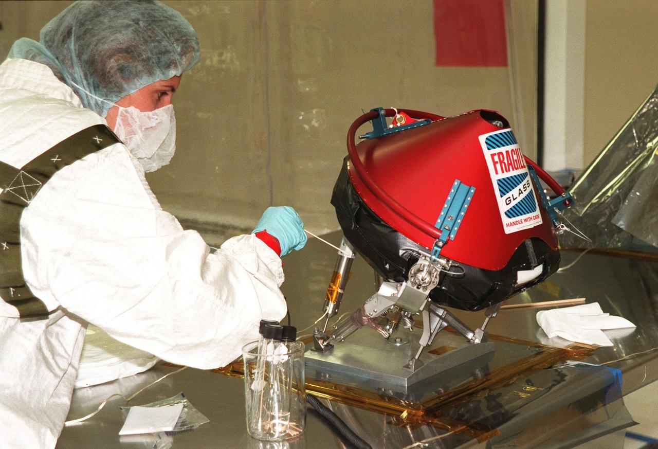 KENNEDY SPACE CENTER, FLA. -- In the Spacecraft Assembly and Encapsulation Facility -2 (SAEF-2), a JPL worker checks the Mars microprobe. Two microprobes will hitchhike on the Mars Polar Lander, scheduled to be launched Jan. 3, 1999, aboard a Delta II rocket. The solar-powered spacecraft is designed to touch down on the Martian surface near the northern-most boundary of the south pole in order to study the water cycle there. The lander also will help scientists learn more about climate change and current resources on Mars, studying such things as frost, dust, water vapor and condensates in the Martian atmosphere. The Mars microprobes, called Deep Space 2, are part of NASA's New Millennium Program. They will complement the climate-related scientific focus of the lander by demonstrating an advanced, rugged microlaser system for detecting subsurface water. Such data on polar subsurface water, in the form of ice, should help put limits on scientific projections for the global abundance of water on Mars