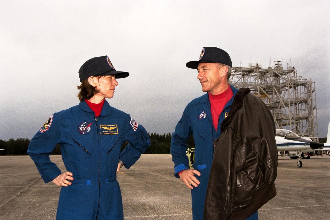 STS-89 Mission Specialist Bonnie Dunbar, Ph.D., at left, and Commander Terrence Wilcutt discuss their upcoming mission at KSC's Shuttle Landing Facility. The eight STS-89 crew members flew into KSC from Johnson Space Center as final preparations are under way toward the scheduled liftoff on Jan. 22 of the Space Shuttle Endeavour on the eighth mission to dock with the Russian Space Station Mir. After docking, STS-89 Mission Specialist Andrew Thomas, Ph.D., will transfer to the space station, succeeding David Wolf, M.D., who will return to Earth aboard Endeavour. Dr. Thomas will live and work on Mir until June. STS-89 is scheduled for a Jan. 22 liftoff at 9:48 p.m. EST