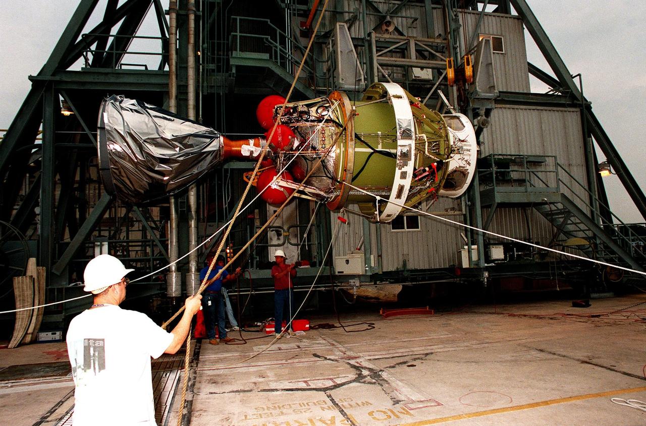 The second stage of a Delta II rocket is prepared for its shift to vertical alongside the gantry at pad 17A at Cape Canaveral Air Station. The rocket is scheduled to be launched on Dec. 10, 1998, heading for Mars and carrying the Mars Climate Orbiter. The orbiter's instruments will monitor the Martian atmosphere and image the planet's surface on a daily basis for 657 days. It will observe the appearance and movement of atmospheric dust and water vapor, as well as characterize seasonal changes on the surface. The detailed images of the surface features will provide important clues to the planet's early climate history and give scientists more information about possible liquid water reserves beneath the surface. The orbiter will primarily support its companion Mars Polar Lander spacecraft, which is planned for launch on Jan. 3, 1999