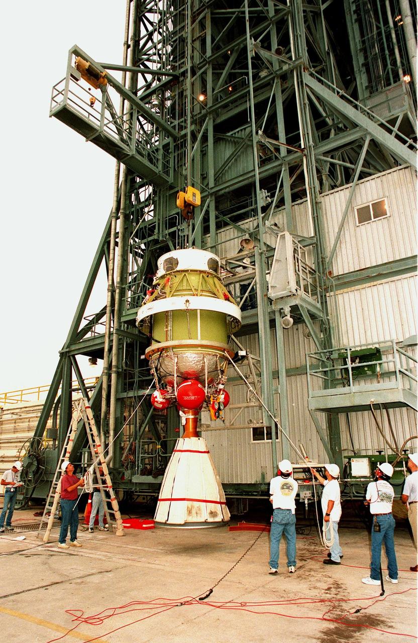 Workers at pad 17A at Cape Canaveral Air Station begin lifting the second stage of a Delta II rocket up the gantry . The rocket is scheduled to be launched on Dec. 10, 1998, heading for Mars and carrying the Mars Climate Orbiter. The orbiter's instruments will monitor the Martian atmosphere and image the planet's surface on a daily basis for 657 days. It will observe the appearance and movement of atmospheric dust and water vapor, as well as characterize seasonal changes on the surface. The detailed images of the surface features will provide important clues to the planet's early climate history and give scientists more information about possible liquid water reserves beneath the surface. The orbiter will primarily support its companion Mars Polar Lander spacecraft, which is planned for launch on Jan. 3, 1999