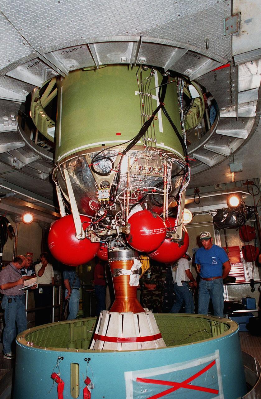 At pad 17A at Cape Canaveral Air Station, the second stage of a Delta II rocket is lowered into the first stage. The rocket is scheduled to be launched on Dec. 10, 1998, heading for Mars and carrying the Mars Climate Orbiter. The orbiter's instruments will monitor the Martian atmosphere and image the planet's surface on a daily basis for 657 days. It will observe the appearance and movement of atmospheric dust and water vapor, as well as characterize seasonal changes on the surface. The detailed images of the surface features will provide important clues to the planet's early climate history and give scientists more information about possible liquid water reserves beneath the surface. The orbiter will primarily support its companion Mars Polar Lander spacecraft, which is planned for launch on Jan. 3, 1999