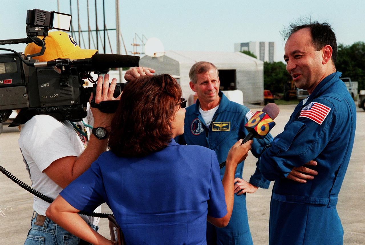 KENNEDY SPACE CENTER, FLA. -- After landing at the Shuttle Landing Facility aboard T-38 trainers, STS-98 Pilot Mark Polansky (right) and Mission Commander Ken Cockrell (center, background) are interviewed by media representatives. Polansky, Cockrell and Mission Specialist Marsha Ivins (not shown) accompanied the U.S. Laboratory module on its transport from Marshall Space Flight Center, Huntsville, to Kennedy aboard NASA's "Super Guppy" aircraft. Scheduled for launch aboard the Shuttle Endeavour on mission STS-98, the laboratory comprises three cylindrical sections with two end cones. Each end-cone contains a hatch opening for entering and exiting the lab. The lab will provide a shirtsleeve environment for research in the areas of life science, microgravity science, Earth science and space science. Designated Flight 5A, this mission is targeted for launch in early 2000
