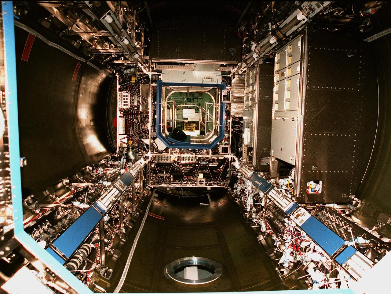KENNEDY SPACE CENTER, FLA. -- The inside of the U.S. laboratory module is seen after the opening of a hatch on one end. An element of the International Space Station, the lab is undergoing pre-launch preparations before its launch aboard the Shuttle Endeavour on mission STS-98. The laboratory comprises three cylindrical sections with two end cones. Each end-cone contains a hatch opening for entering and exiting the lab. The lab will provide a shirtsleeve environment for research in the areas of life science, microgravity science, Earth science and space science. Designated Flight 5A, this mission is targeted for launch in early 2000
