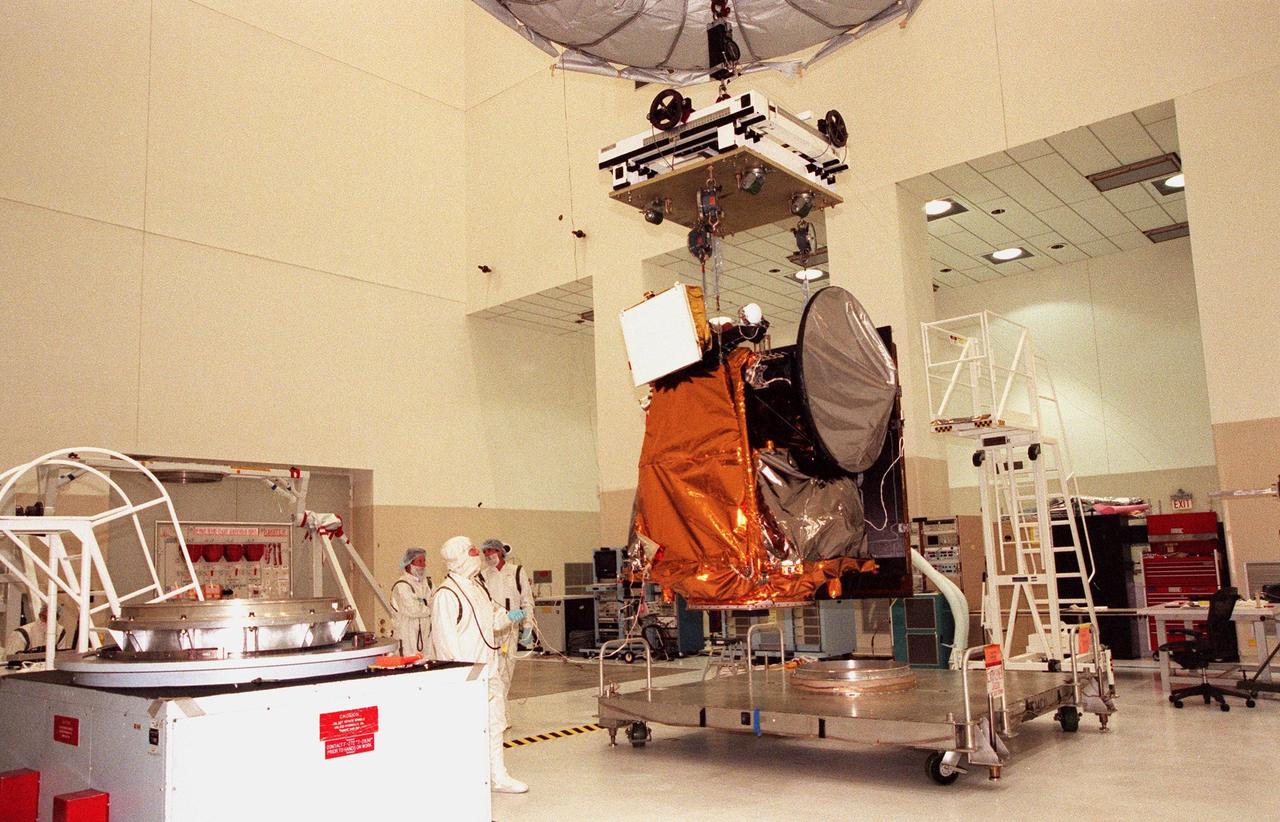 KENNEDY SPACE CENTER, FLA. -- In the Spacecraft Assembly and Encapsulation Facility -2 (SAEF-2), the Mars Climate Orbiter is lifted from the workstand to move it to another site for a spin test. Targeted for launch aboard a Delta II rocket on Dec. 10, 1998, the orbiter is heading for Mars where it will primarily support its companion Mars Polar Lander spacecraft, which is planned for launch on Jan. 3, 1999. The orbiter's instruments will monitor the Martian atmosphere and image the planet's surface on a daily basis for 687 Earth days. It will observe the appearance and movement of atmospheric dust and water vapor, as well as characterize seasonal changes on the surface. The detailed images of the surface features will provide important clues to the planet's early climate history and give scientists more information about possible liquid water reserves beneath the surface