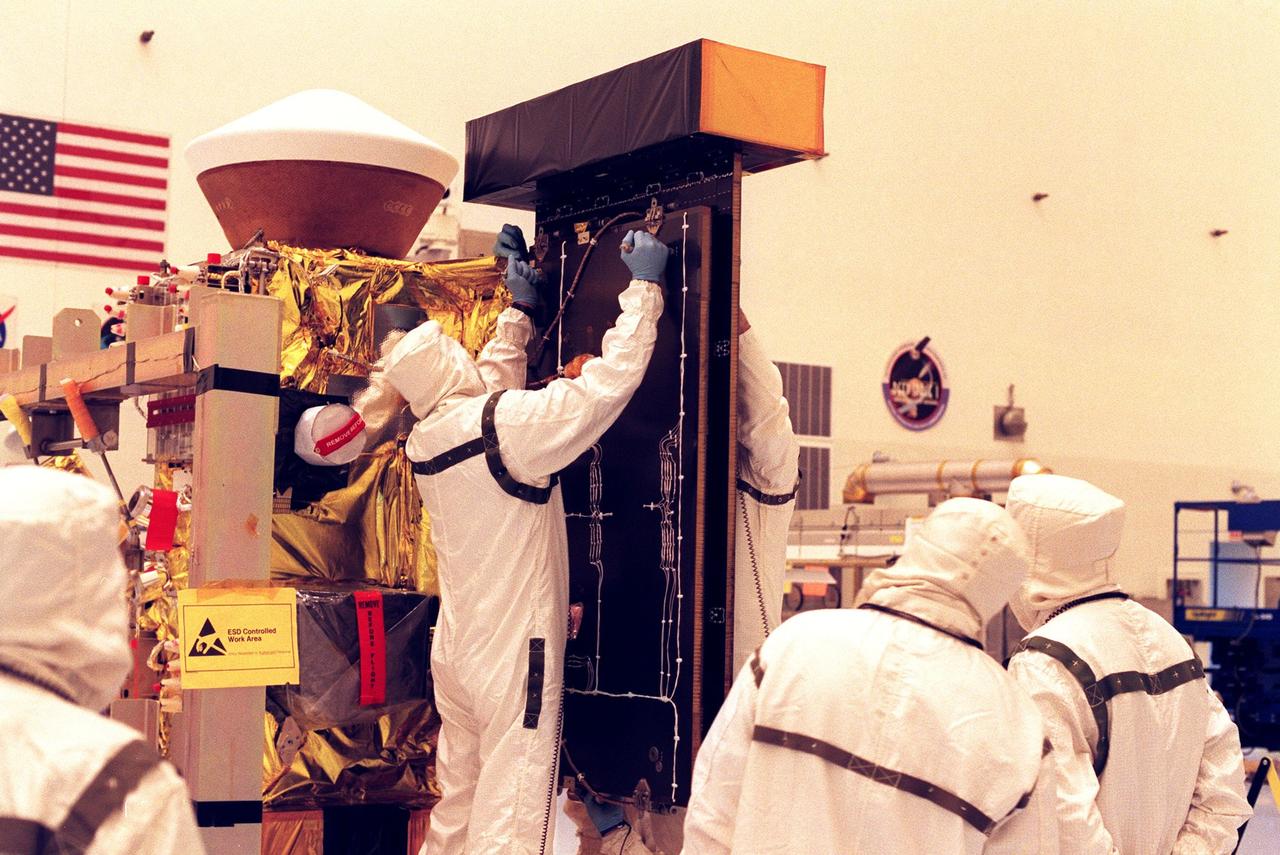 In the Payload Hazardous Servicing Facility, workers begin removing the Stardust solar panels for testing. The spacecraft Stardust will use a unique medium called aerogel to capture comet particles flying off the nucleus of comet Wild 2 in January 2004, plus collect interstellar dust for later analysis. Stardust will be launched aboard a Boeing Delta 7426 rocket from Complex 17, Cape Canaveral Air Station, targeted for Feb. 6, 1999. The collected samples will return to Earth in a re-entry capsule to be jettisoned from Stardust as it swings by Earth in January 2006