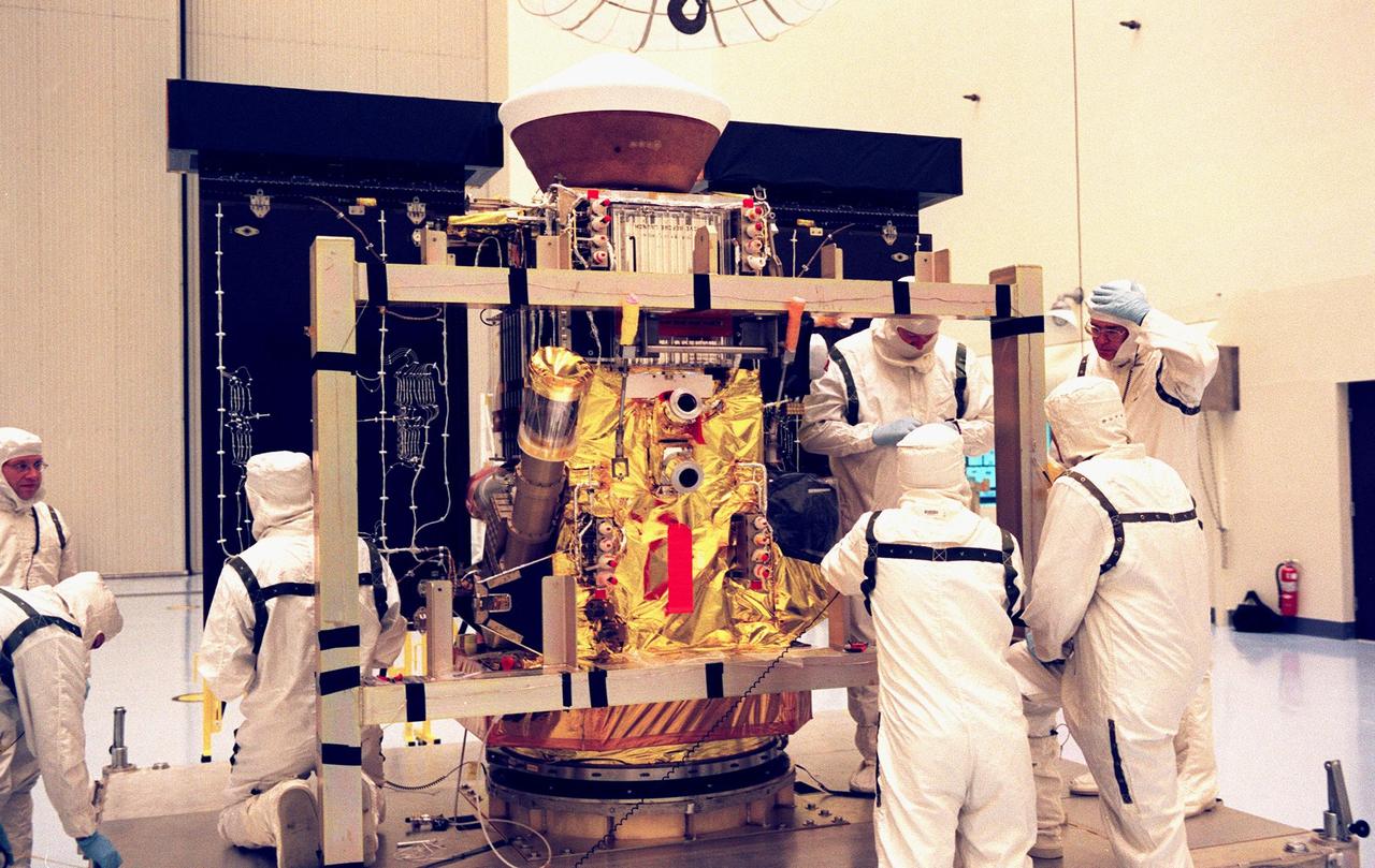 In the Payload Hazardous Servicing Facility, workers work at removing the Stardust solar panels for testing. The spacecraft Stardust will use a unique medium called aerogel to capture comet particles flying off the nucleus of comet Wild 2 in January 2004, plus collect interstellar dust for later analysis. Stardust will be launched aboard a Boeing Delta 7426 rocket from Complex 17, Cape Canaveral Air Station, targeted for Feb. 6, 1999. The collected samples will return to Earth in a re-entry capsule to be jettisoned from Stardust as it swings by Earth in January 2006