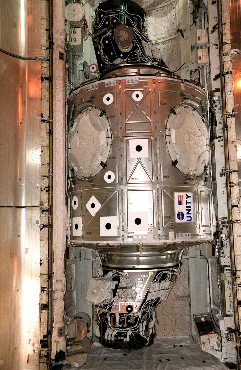 The Unity connecting module rests inside the payload bay of the orbiter Endeavour at Launch Pad 39A. The first U.S. element of the International Space Station (ISS), Unity is scheduled for launch Dec. 3, 1998, on Mission STS-88. The Unity is a connecting passageway to the living and working areas of ISS. While on orbit, the flight crew will deploy Unity from the payload bay and attach it to the Russian-built Zarya control module which will be in orbit at that time. The mission is expected to last nearly 12 days, landing back at the Kennedy Space Center on Dec. 14