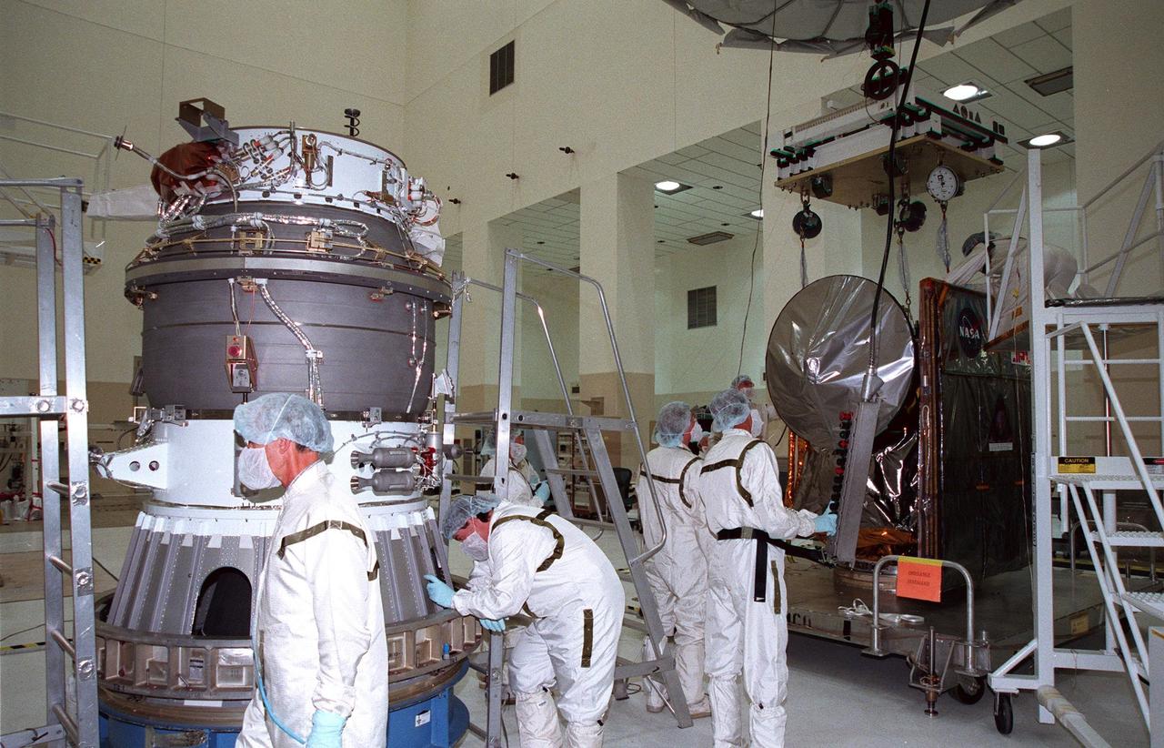 KENNEDY SPACE CENTER, FLA. -- In the Spacecraft Assembly and Encapsulation Facility -2 (SAEF-2), the third stage of the Boeing Delta II launch vehicle (left) waits for mating with the Mars Climate Orbiter (right). The third stage is a solid-propellant Thiokol Star 48B booster, the same final stage used in the 1996 launch of Mars Global Surveyor. Targeted for launch on Dec. 10, 1998, the orbiter is heading for Mars where it will primarily support its companion Mars Polar Lander spacecraft, which is planned for launch on Jan. 3, 1999. The orbiter's instruments will monitor the Martian atmosphere and image the planet's surface on a daily basis for 687 Earth days. It will observe the appearance and movement of atmospheric dust and water vapor, as well as characterize seasonal changes on the surface. The detailed images of the surface features will provide important clues to the planet's early climate history and give scientists more information about possible liquid water reserves beneath the surface