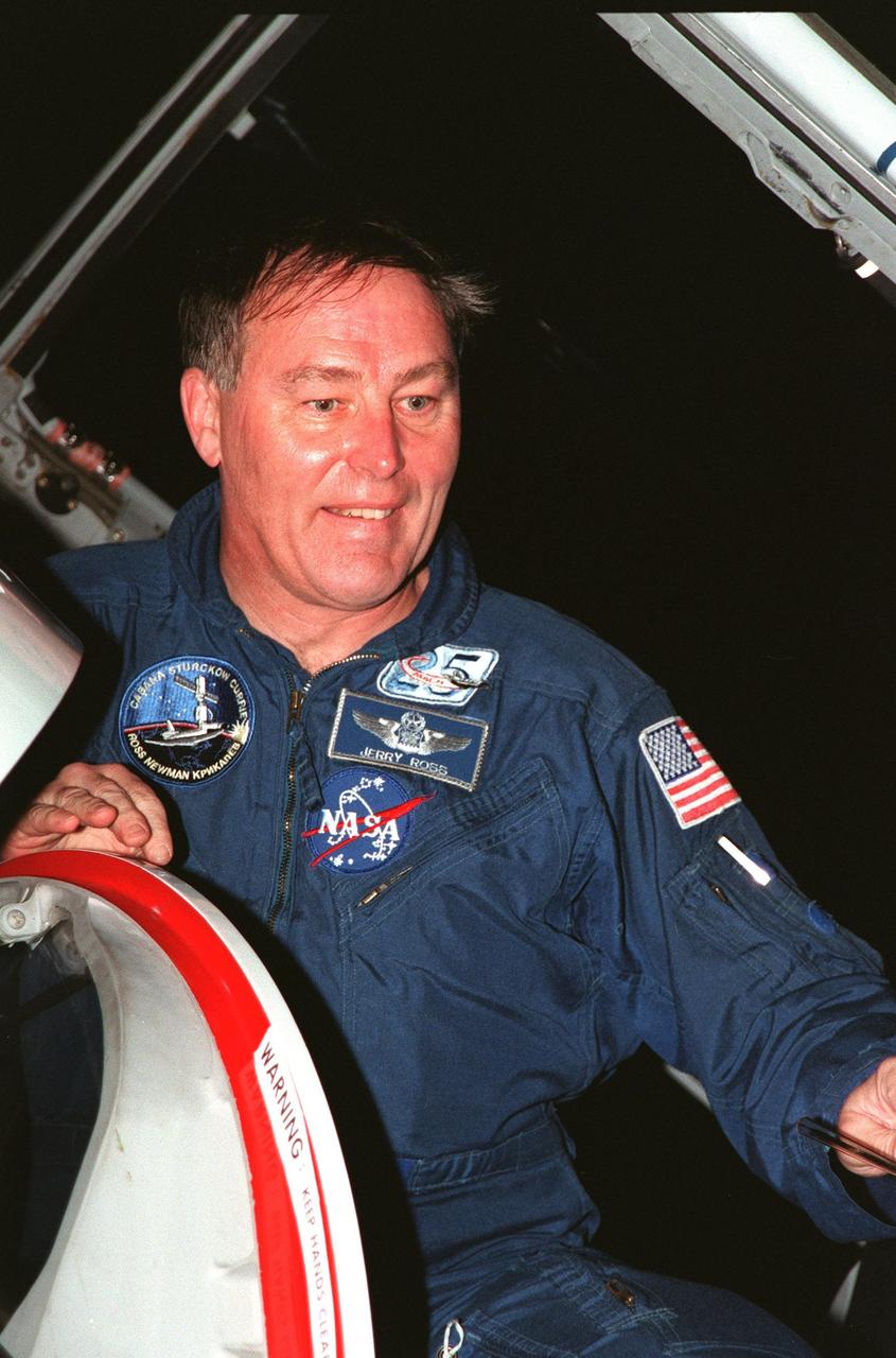 A smiling STS-88 Mission Specialist Jerry L. Ross prepares to exit the T-38 jet aircraft that brought him to the Shuttle Landing Facility. He joins the five other crew members, Commander Robert D. Cabana, Pilot Frederick W. "Rick" Sturckow, and Mission Specialists Nancy J. Currie, James H. Newman and Sergei Konstantinovich Krikalev, a Russian cosmonaut, for prelaunch preparations for mission STS-88 aboard Space Shuttle Endeavour. The scheduled time of launch is 3:56 a.m. EST on Dec. 3 from Launch Pad 39A. The mission is the first U.S. launch for the International Space Station. Endeavour carries the Unity connecting module which the crew will be mating with the Russian-built Zarya control module already in orbit. In addition to Unity, Endeavour will carry two small replacement electronics boxes for possible repairs to Zarya batteries. The mission is scheduled to last nearly 12 days