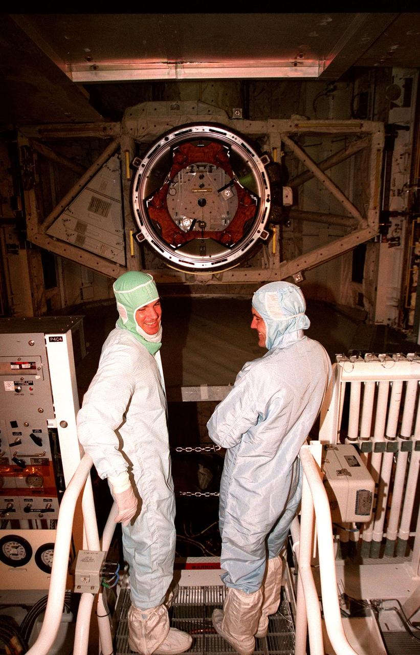 At Launch Pad 39A, STS-88 Pilot Frederick W. "Rick" Sturckow (at left) and Commander Robert D. Cabana look over the Unity connecting module and its two attached pressurized mating adapters. Unity is in the payload bay of the Space Shuttle Endeavour, awaiting liftoff of Mission STS-88. Cabana, Sturckow and the other four members of the STS-88 crew arrived at KSC in the early morning hours of Nov. 30 for prelaunch preparations. The other crew members are Mission Specialists Nancy J. Currie, James H. Newman and Sergei Konstantinovich Krikalev, a Russian cosmonaut. The scheduled liftoff is at 3:56 a.m. on Dec. 3. Unity is the primary payload of the mission, which is the first U.S. launch for the International Space Station. The crew will be mating Unity with the Russian-built Zarya control module already in orbit. In addition to Unity, Endeavour will carry two small replacement electronics boxes for possible repairs to Zarya batteries. The mission is scheduled to last nearly 12 days