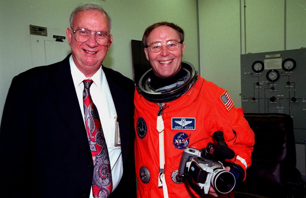 KENNEDY SPACE CENTER, FLA. -- In the Operations and Checkout Building, STS-88 Mission Specialist Jerry L. Ross (right) takes part in a complete suit check before launch. Standing with him is Owen Bertrand, chief of the Vehicle Integration Test office at Johnson Space Center. This is Bertrand's last launch before retiring in January. Mission STS-88 is expected to launch at 3:56 a.m. EST with the six-member crew aboard Space Shuttle Endeavour on Dec. 3. Endeavour carries the Unity connecting module, which the crew will be mating with the Russian-built Zarya control module already in orbit. In addition to Unity, two small replacement electronics boxes are on board for possible repairs to Zarya batteries. The mission is expected to last 11 days, 19 hours and 49 minutes, landing at 10:17 p.m. EST on Dec. 14