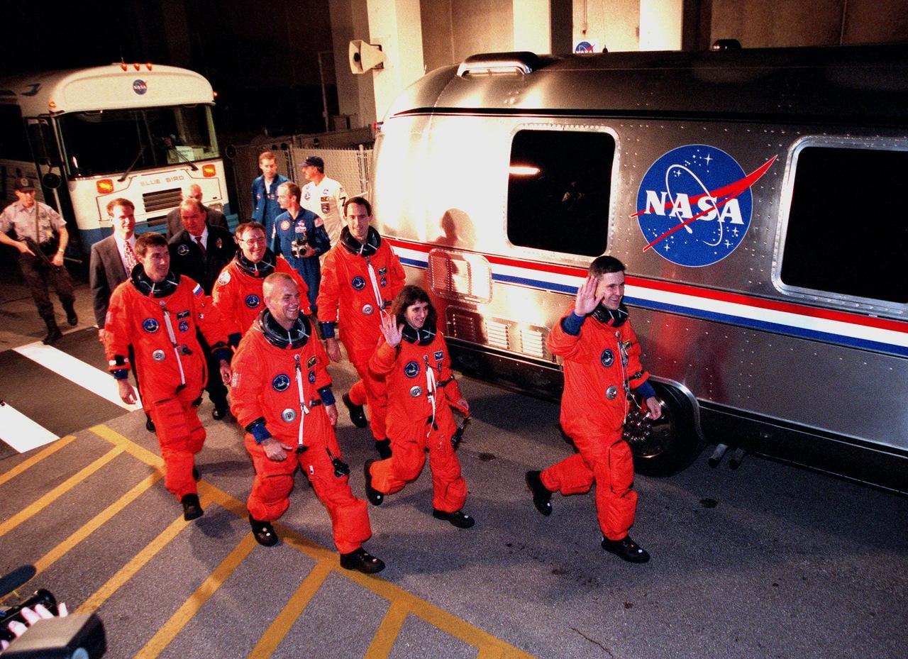 After leaving the Operations and Checkout Building, the STS-88 crew approach the Astrovan for their trip to Launch Pad 39A. In the back row are (left to right) Mission Specialist Sergei Konstantinovich Krikalev, a Russian cosmonaut, and Mission Specialists Jerry L. Ross and James H. Newman. In the front row (left to right) are Pilot Frederick W. "Rick" Sturckow, Mission Specialist Nancy J. Currie and Commander Robert D. Cabana. STS-88 is expected to launch at 3:56 a.m. EST with the six-member crew aboard Space Shuttle Endeavour on Dec. 3. Endeavour carries the Unity connecting module, which the crew will be mating with the Russian-built Zarya control module already in orbit. In addition to Unity, two small replacement electronics boxes are on board for possible repairs to Zarya batteries. The mission is expected to last 11 days, 19 hours and 49 minutes, with landing at 10:17 p.m. EST on Dec. 14