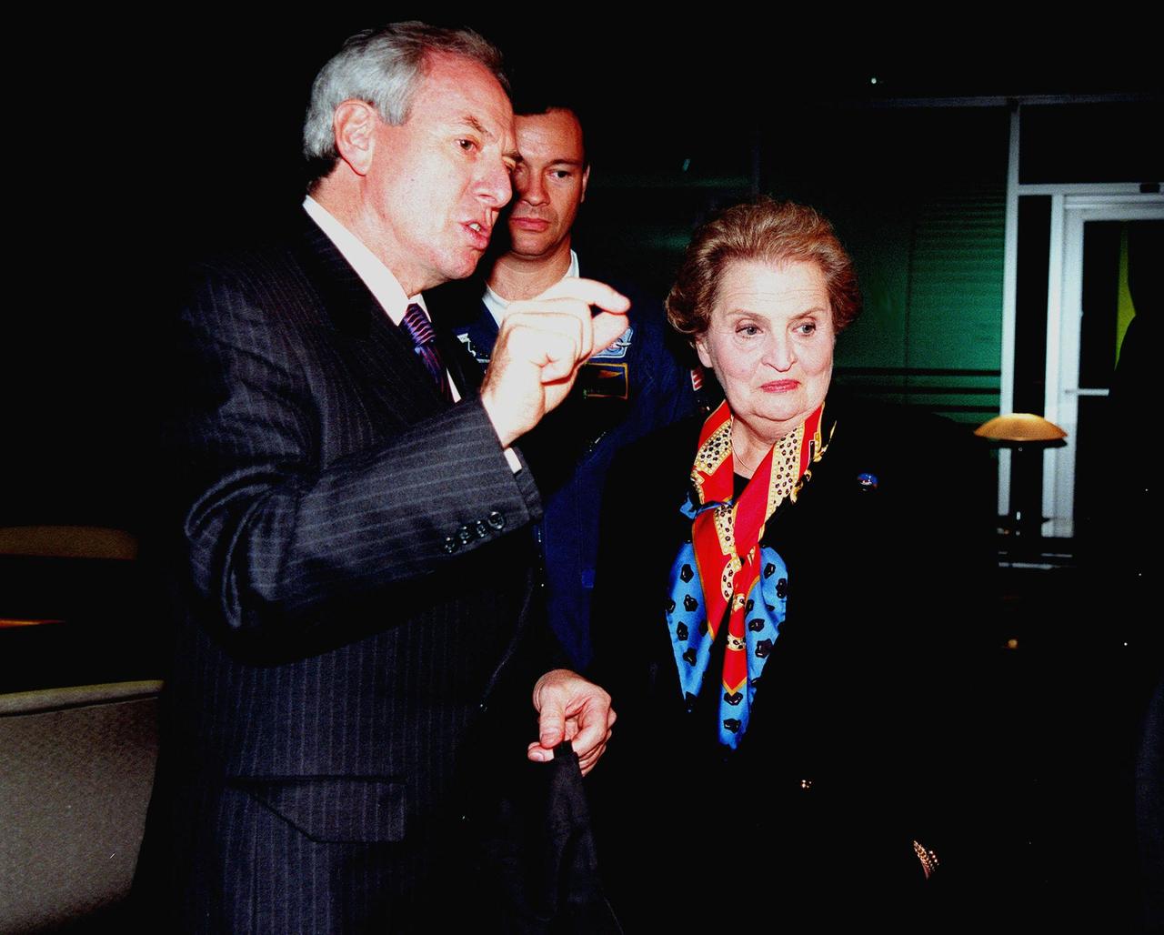 KENNEDY SPACE CENTER, FLA. -- U.S. Secretary of State Madeleine Albright talks with NASA Administrator Daniel Goldin (at left) in the VIP lounge at the Apollo/Saturn V Center while awaiting launch of Mission STS-88, the first U.S. launch for the International Space Station. Astronaut Michael Lopez-Alegria is looking on in background