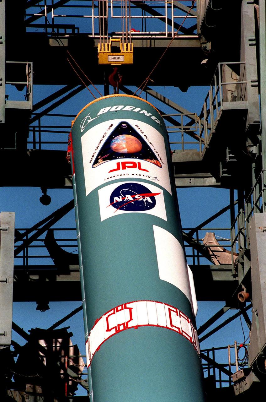 The first stage of a Delta II rocket is lifted up the gantry at Launch Complex 17B, Cape Canaveral Air Station. The rocket will be used to launch the Mars Polar Lander on Jan. 3, 1999. The lander is a solar-powered spacecraft designed to touch down on the Martian surface near the northern-most boundary of the south pole in order to study the water cycle there. The lander also will help scientists learn more about climate change and current resources on Mars, studying such things as frost, dust, water vapor and condensates in the Martian atmosphere. It is the second spacecraft to be launched in a pair of Mars '98 missions. The first is the Mars Climate Orbiter, to be launched aboard a Delta II rocket from Launch Complex 17A on Dec. 10, 1998