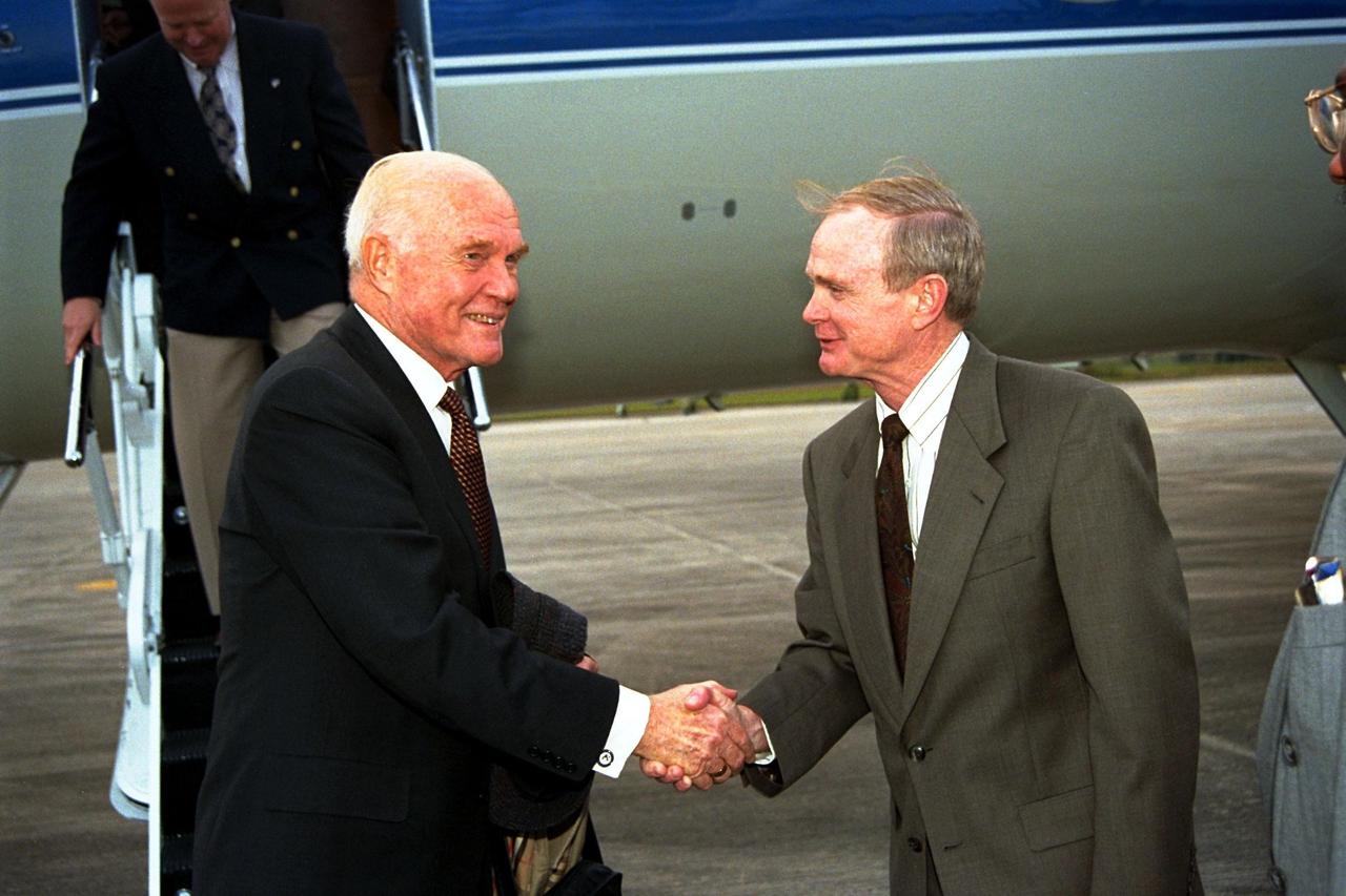 Ohio Senator John Glenn, at left, shakes hands with Kennedy Space Center (KSC) Director Roy Bridges shortly after Glenn's arrival at KSC's Shuttle Landing Facility on Jan. 20 to tour KSC operational areas and to view the launch of STS-89 later this week. Glenn, who made history in 1962 as the first American to orbit the Earth, completing three orbits in a five-hour flight aboard Friendship 7, will fly his second space mission aboard Space Shuttle Discovery this October. Glenn is retiring from the Senate at the end of this year and will be a payload specialist aboard STS-95