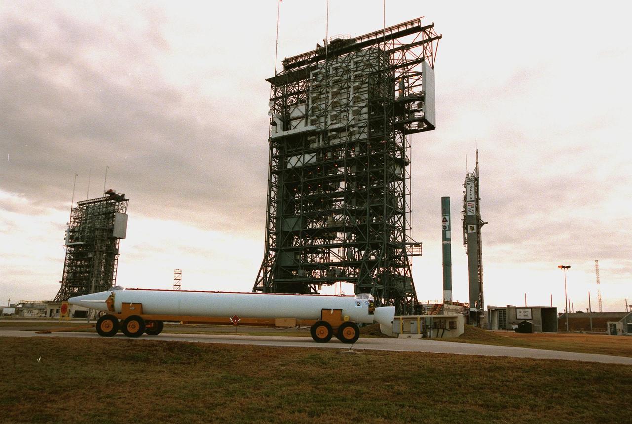 KENNEDY SPACE CENTER, FLA. -- On Pad 17B, Cape Canaveral Air Station, a solid rocket booster waits for mating with the Delta II rocket (in background) carrying the Mars Polar Lander. The rocket will be used to launch the Mars Polar Lander on Jan. 3, 1999. The lander is a solar-powered spacecraft designed to touch down on the Martian surface near the northern-most boundary of the south pole in order to study the water cycle there. The lander also will help scientists learn more about climate change and current resources on Mars, studying such things as frost, dust, water vapor and condensates in the Martian atmosphere. It is the second spacecraft to be launched in a pair of Mars '98 missions. The first is the Mars Climate Orbiter, to be launched aboard a Delta II rocket from Launch Complex 17A in December 1998