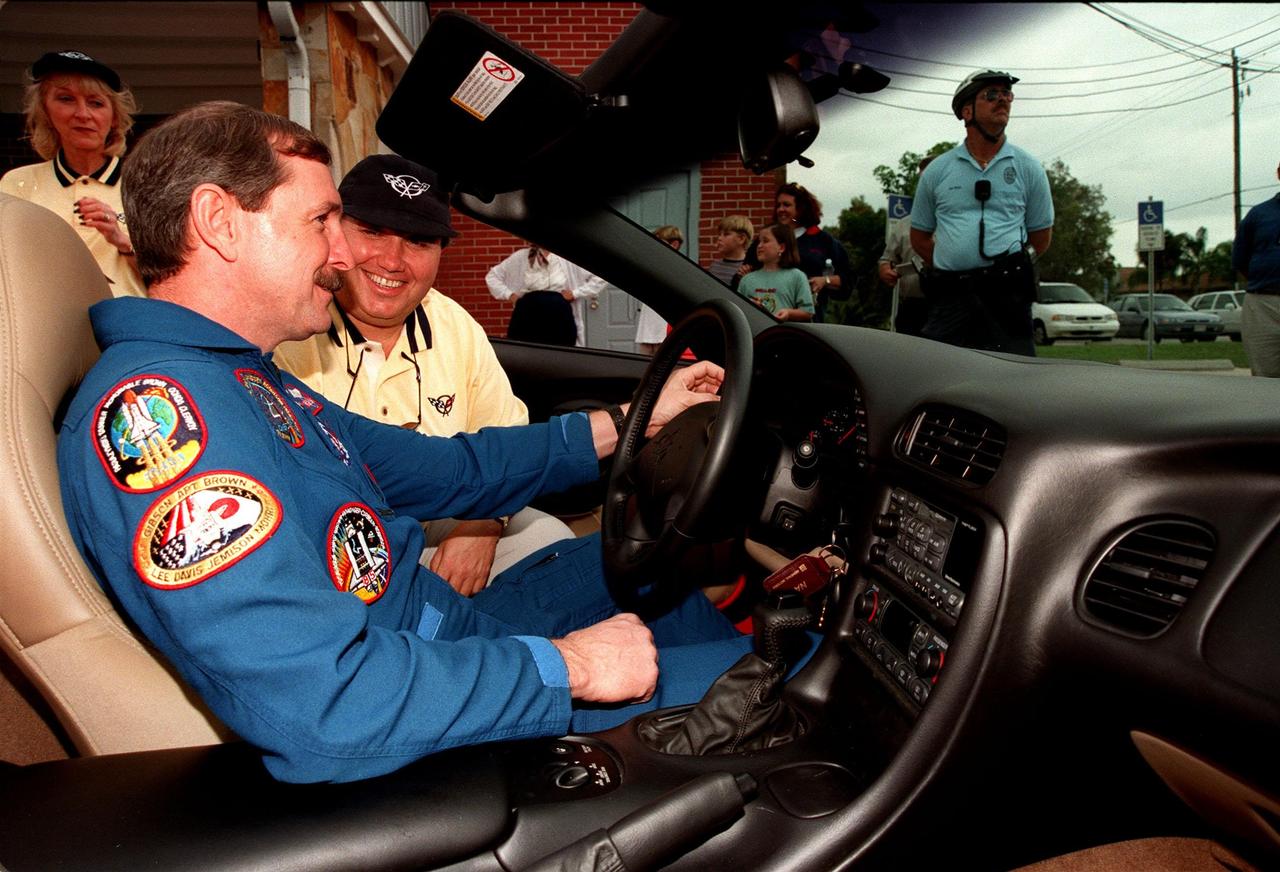 STS-95 Commander Curtis L. Brown Jr. examines the heads up display in the 1999 C-5 Corvette convertible in which he will be riding during a parade down State Road A1A in nearby Cocoa Beach as Dan Adovasio, a parade coordinator, looks on. Organizers of the parade include the Cocoa Beach Area Chamber of Commerce, the Brevard County Tourist Development Council, and the cities of Cape Canaveral and Cocoa Beach. The parade is reminiscent of those held after missions during the Mercury Program