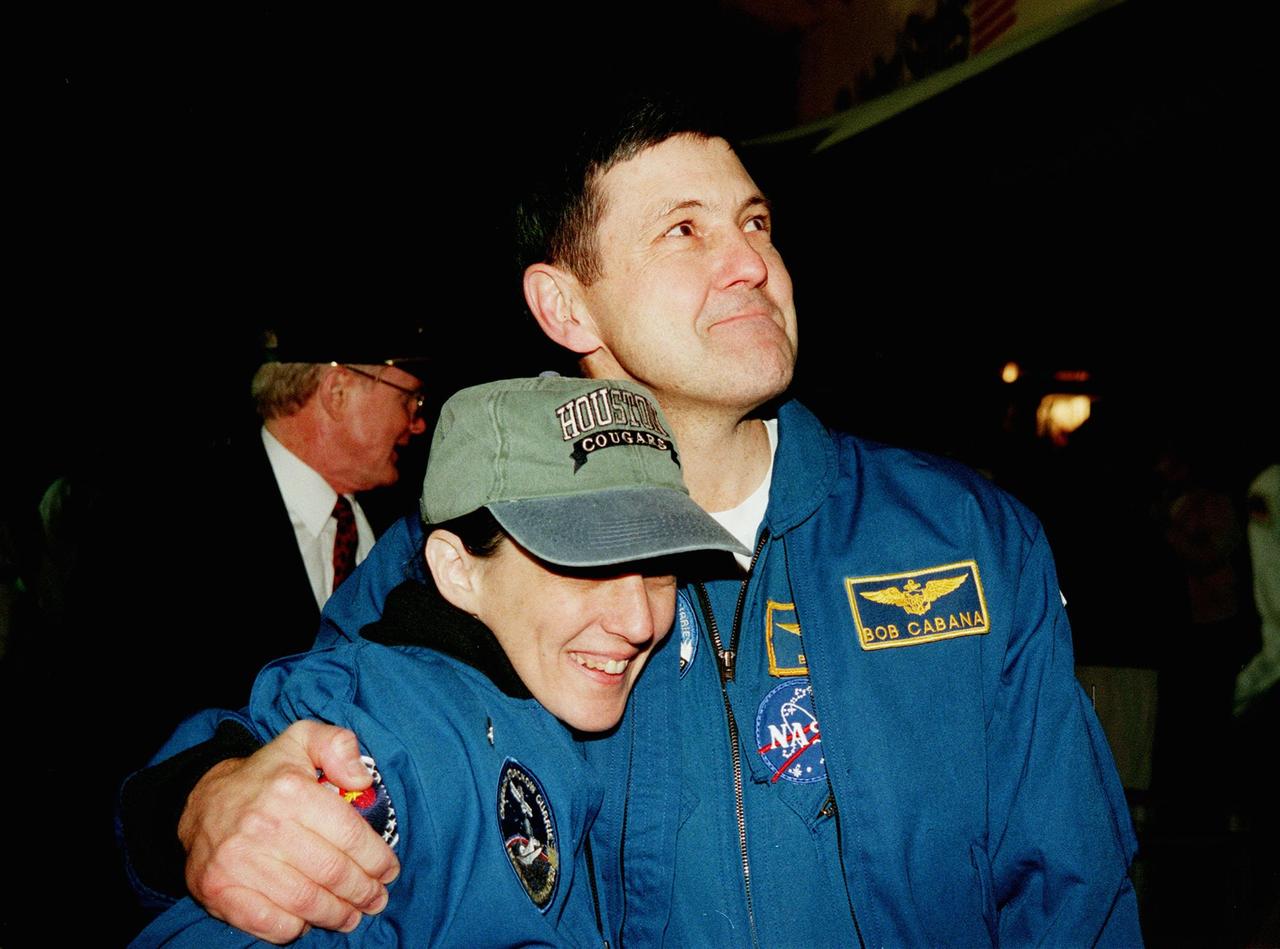 STS-88 Mission Specialist Nancy J. Currie (left) gets a hug of camaraderie from Commander Robert D. Cabana after their landing on Runway 15 at 10:53:29 p.m. EST aboard orbiter Endeavour. Also aboard were Pilot Frederick W. "Rick" Sturckow and Mission Specialists Jerry L. Ross, James H. Newman and Sergei Konstantinovich Krikalev, a Russian cosmonaut. On the 4.6-million-mile, nearly 12-day flawless mission, Endeavour carried the U.S.-built Unity connecting module to begin construction of the International Space Station. The crew successfully mated Unity with the Russian-built Zarya control module during three space walks. With this mission, Ross completed seven space walks totaling 44 hours and 9 minutes, more than any other American space walker. Newman moved into third place for U.S. space walks with a total of 28 hours and 27 minutes on four excursions