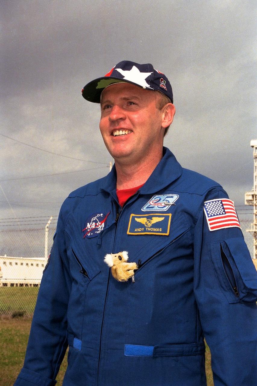 KENNEDY SPACE CENTER,  Fla. -- STS-89 Mission Specialist Andrew Thomas, Ph.D., poses at KSC's Launch Pad 39A wearing a miniature koala bear on the day before the scheduled launch of Space Shuttle Endeavour that will carry him up to the Russian Space Station Mir. Final preparations are under way toward liftoff on Jan. 22 on the eighth mission to dock with Mir. After docking, Dr. Thomas will transfer to the space station, succeeding David Wolf, M.D., who will return to Earth aboard Endeavour. Dr. Thomas, who was born and educated in South Australia, will live and work on Mir until June. STS-89 is scheduled for liftoff at 9:48 p.m. EST