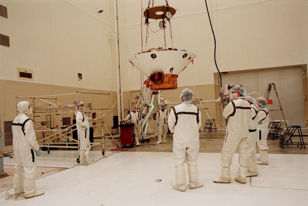 KENNEDY SPACE CENTER, FLA. -- Workers in the Spacecraft Assembly and Encapsulation Facility-2 (SAEF-2) lift the Mars Polar Lander to move it to a spin table for testing. The lander, which will be launched on Jan. 3, 1999, is a solar-powered spacecraft designed to touch down on the Martian surface near the northern-most boundary of the south pole in order to study the water cycle there. The lander also will help scientists learn more about climate change and current resources on Mars, studying such things as frost, dust, water vapor and condensates in the Martian atmosphere. It is the second spacecraft to be launched in a pair of Mars '98 missions. The first is the Mars Climate Orbiter, which is due to be launched aboard a Delta II rocket from Launch Complex 17A on Dec. 11, 1998
