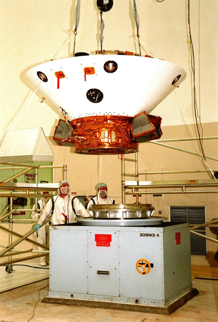 KENNEDY SPACE CENTER, FLA. -- In the Spacecraft Assembly and Encapsulation Facility-2 (SAEF-2), the Mars Polar Lander is lowered toward a spin table for testing. The lander, which will be launched on Jan. 3, 1999, is a solar-powered spacecraft designed to touch down on the Martian surface near the northern-most boundary of the south pole in order to study the water cycle there. The lander also will help scientists learn more about climate change and current resources on Mars, studying such things as frost, dust, water vapor and condensates in the Martian atmosphere. It is the second spacecraft to be launched in a pair of Mars '98 missions. The first is the Mars Climate Orbiter, which is due to be launched aboard a Delta II rocket from Launch Complex 17A on Dec. 11, 1998