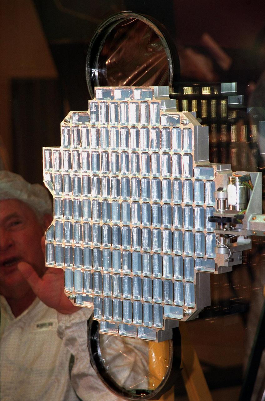 In the Payload Hazardous Servicing Facility, the aerogel grid is fully deployed from the Stardust Sample Return Capsule (SRC) for final closeout. Stardust will use a unique medium called aerogel to capture comet particles flying off the nucleus of comet Wild 2 in January 2004, plus collect interstellar dust for later analysis. The collected samples will return to Earth in the SRC to be jettisoned as it swings by Earth in January 2006. Stardust is scheduled to be launched aboard a Boeing Delta 7426 rocket from Complex 17, Cape Canaveral Air Station, on Feb. 6, 1999